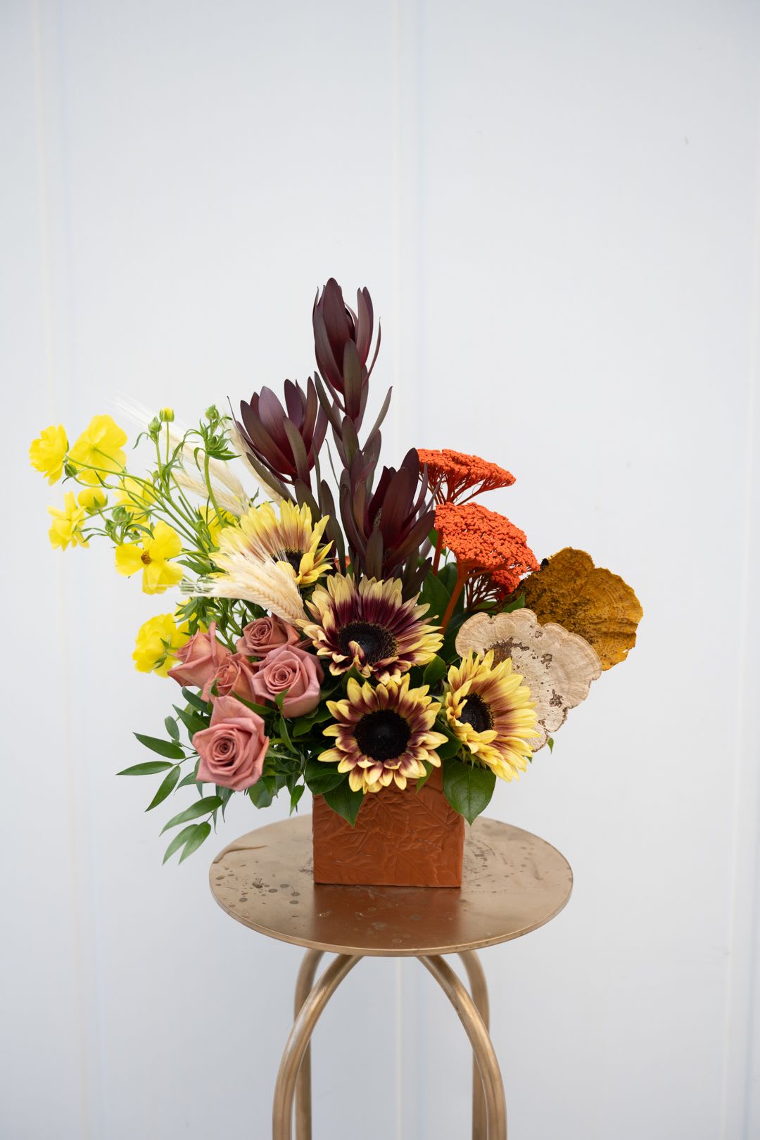 AUTUMN LEAVES  - Embossed ceramic container filled with Barista roses, Firewalker sunflowers, Sunset Safari, Butterfly Ranunculus, Achilles &amp; accents of dried flowers - perfect for the fall. 