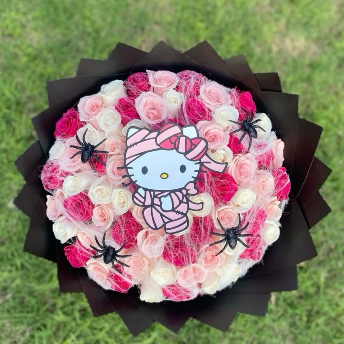 Mummy  kitty bouquet  - Creepily beautiful, made up of, hot pink, light pink and white roses, spider web, spiders wrapped in solid black paper, order it today
