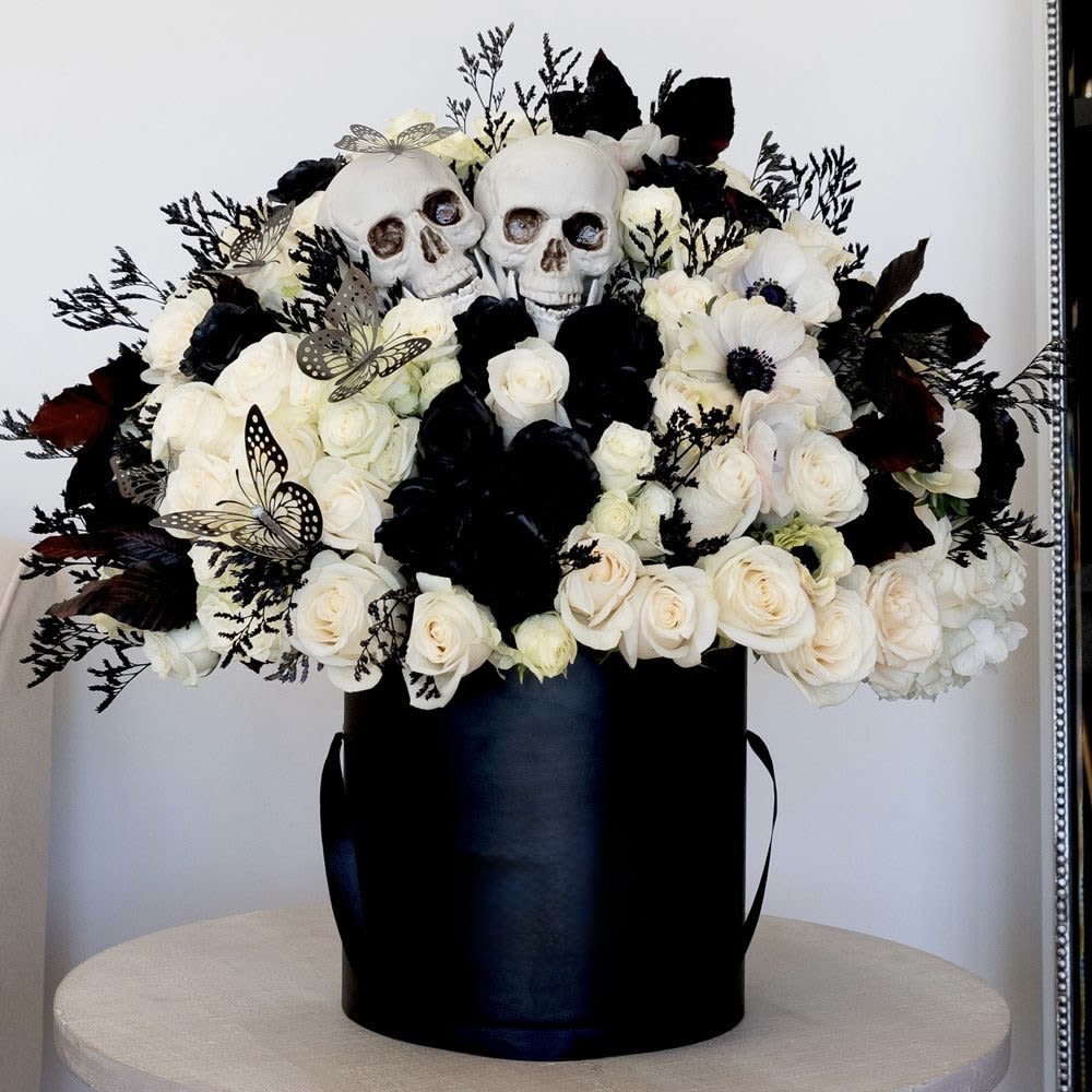 Black and white skull box ( spooky season ) - Elegantly deluxe box prepared for unique details for unique people, made up of white and black roses black foliage, butterflies and decorative bats, and a couple of decorative skull heads order it today.