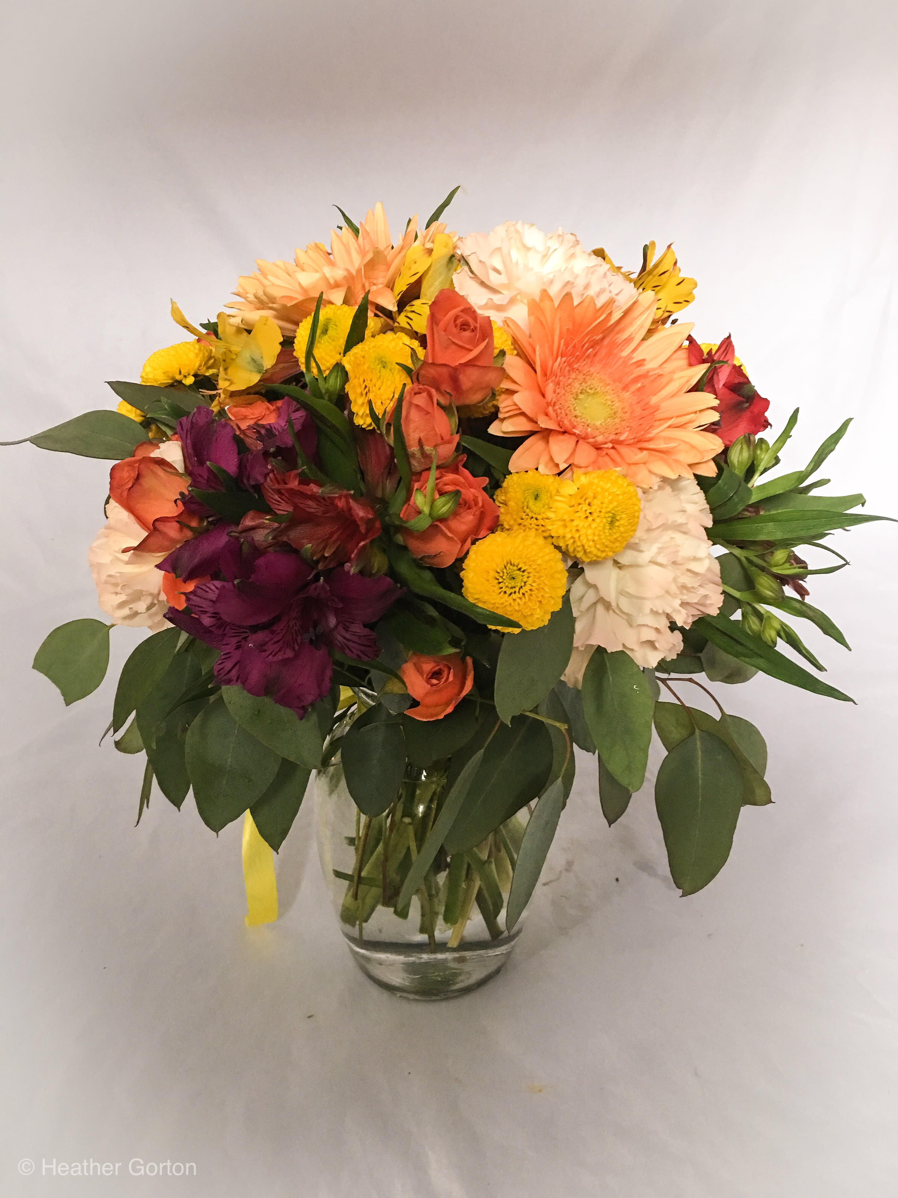 Farmstead Farmstead - Eucalyptus and sage greenery with burgundy and rustic tones throughout make this arrangement classic and high style.