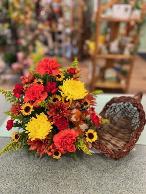  Autumn Cornucopia (AC) - A bountiful of Autumn blooms fill this wicker cornucopia with flowers such as daisies, mums, carnations and more.