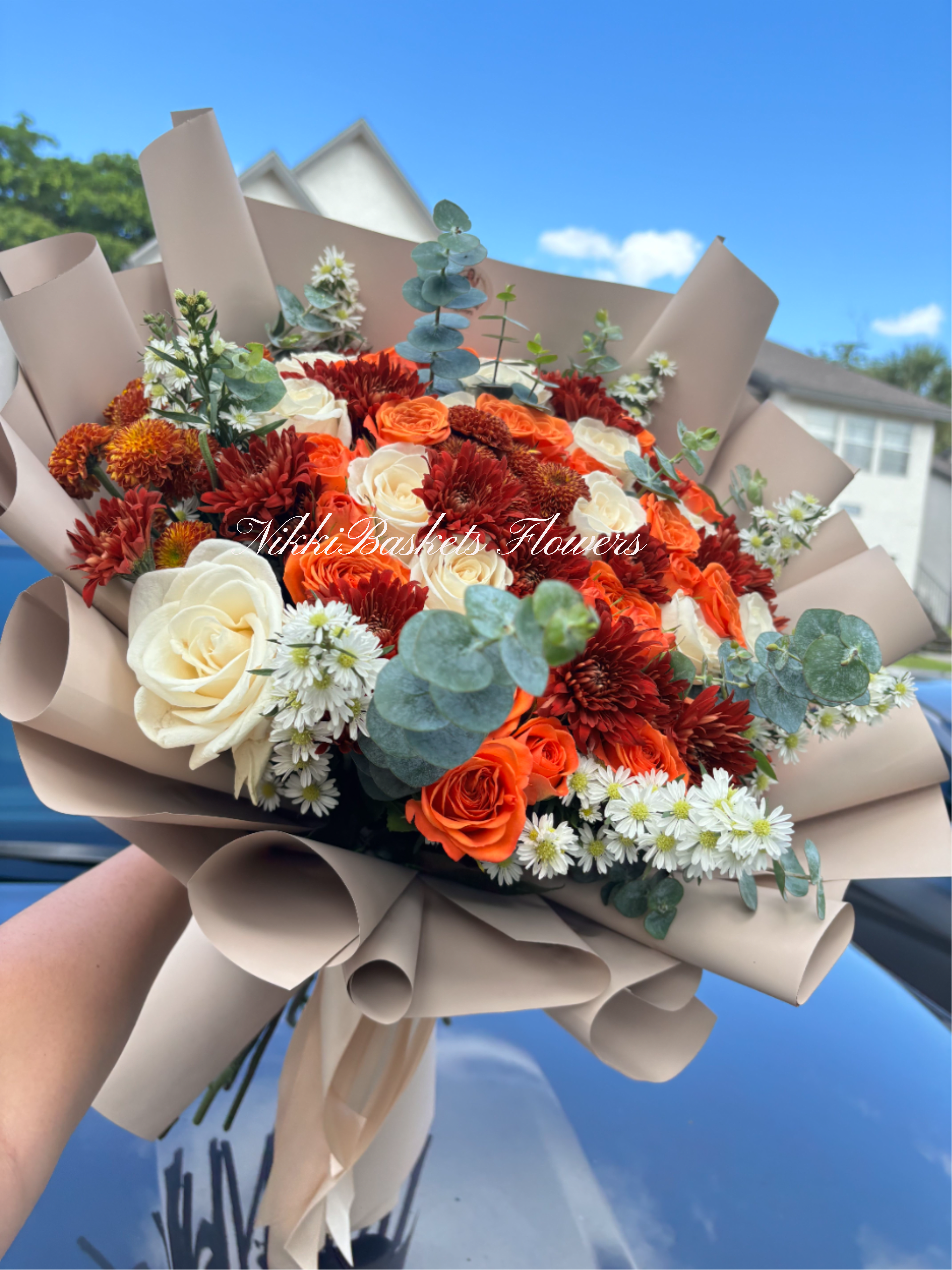 Autumn Harmony Bouquet - Autumn Harmony Bouquet  Warm, elegant, and full of charm — our Autumn Harmony Bouquet captures the cozy essence of the season. Featuring a stunning blend of cream and orange roses, deep red chrysanthemums, delicate white daisies, and eucalyptus accents, this bouquet brings together texture and color in perfect balance. Wrapped in soft beige waterproof paper, it’s ideal for birthdays, anniversaries, or simply to brighten someone’s day with a touch of fall beauty.  Perfect for: Seasonal celebrations, warm gestures, and heartfelt surprises. Note: Wrapping paper is waterproof. Keeping it on is optional. Trim stems ½ inch at an angle and change water every 1–2 days to keep your bouquet fresh.