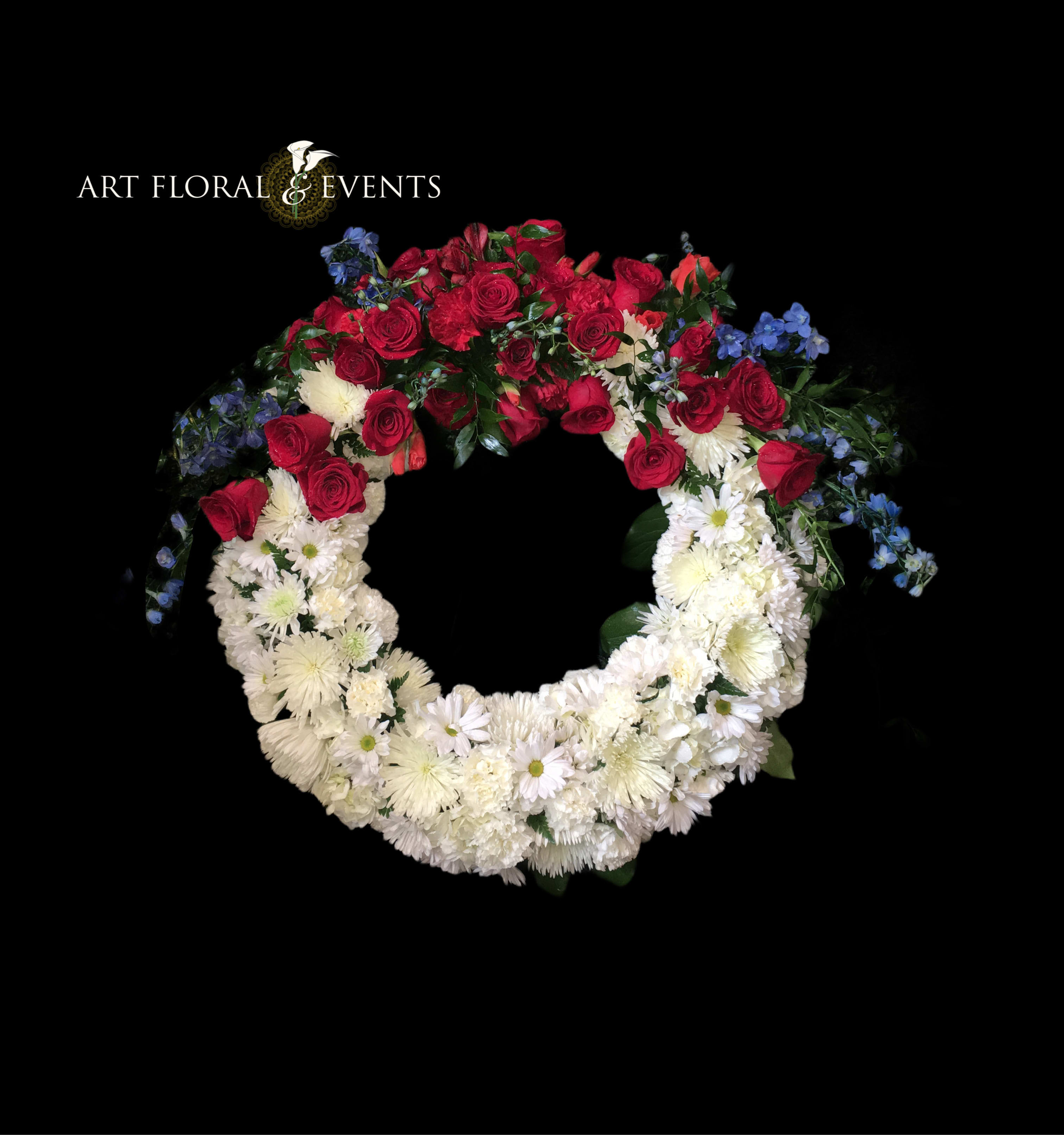 Eternal Remembrance Wreath - Send a message of sympathy with this uniquely designed wreath featuring chrysanthemums, red roses, blue delphinium, and eucalyptus! (easel included)
