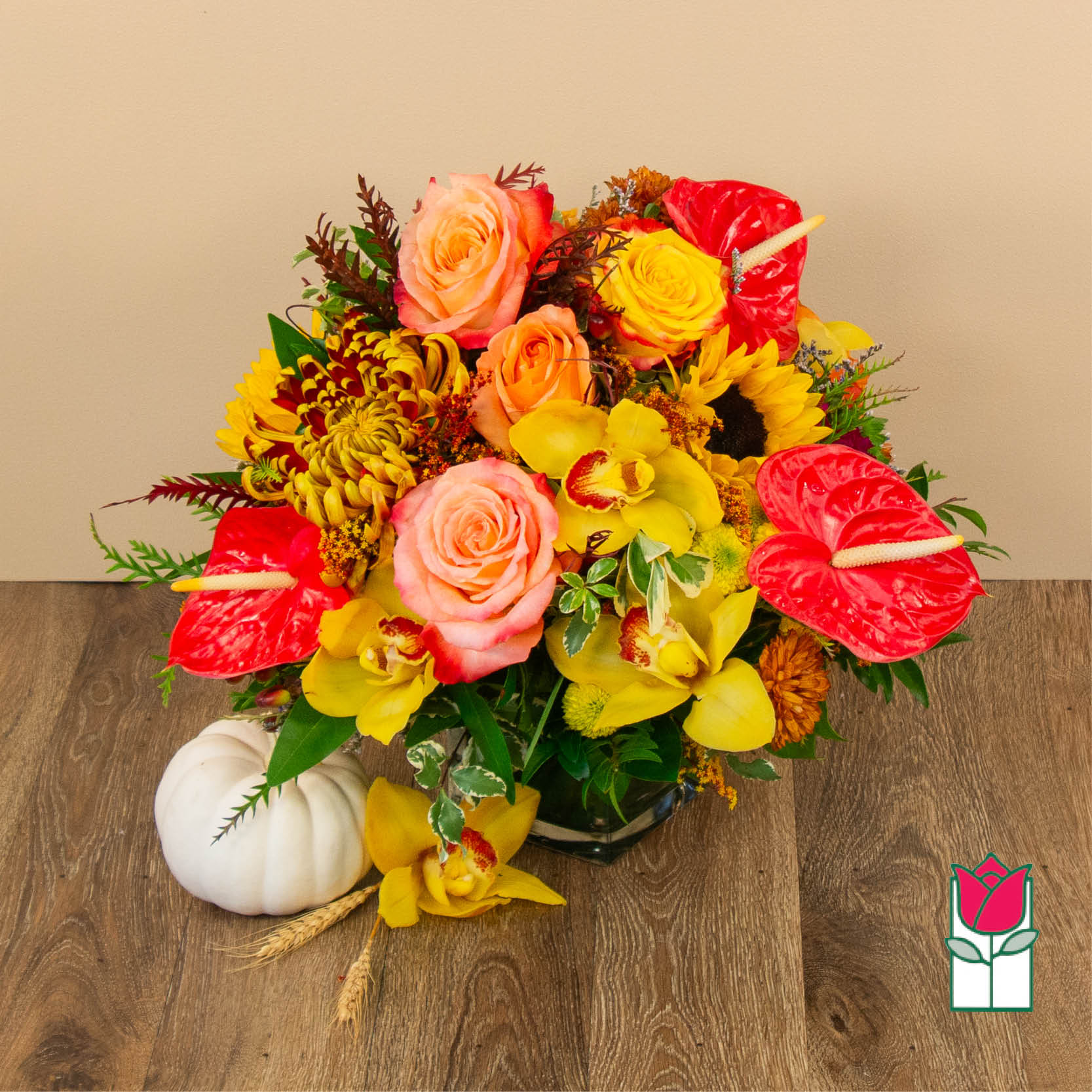 Beretania's Apricot Fall Bouquet - Get ready to embrace the cozy charm of fall with our Beretania Florist Autumn themed floral arrangement. Bursting with the vibrant hues and natural beauty of the season, this arrangement is perfect for adding a touch of autumnal elegance to your home or gifting it to someone special.  Crafted with care by our skilled florists, our fall collection features a delightful medley of fall-inspired blooms. Rich colored roses evoke the warmth of a crackling fireplace, while golden sunflowers and deep orange lilies mirror the changing leaves outdoors. Accents of burgundy and plum add depth and sophistication to the arrangement.  Nestled among the blossoms are rustic elements like dried wheat stalks and miniature pumpkins upon availability, creating a rustic yet refined look. This arrangement is housed in a classic reusable, adding a touch of natural beauty to any room.  Whether you're looking to celebrate a special occasion or simply want to bring the essence of fall indoors, our fall collection floral arrangements captures the spirit of the season perfectly. Place it as a centerpiece on your dining table or gift it to a loved one to share the beauty of autumn. It's the perfect way to welcome the crisp air and changing leaves of fall into your life. 