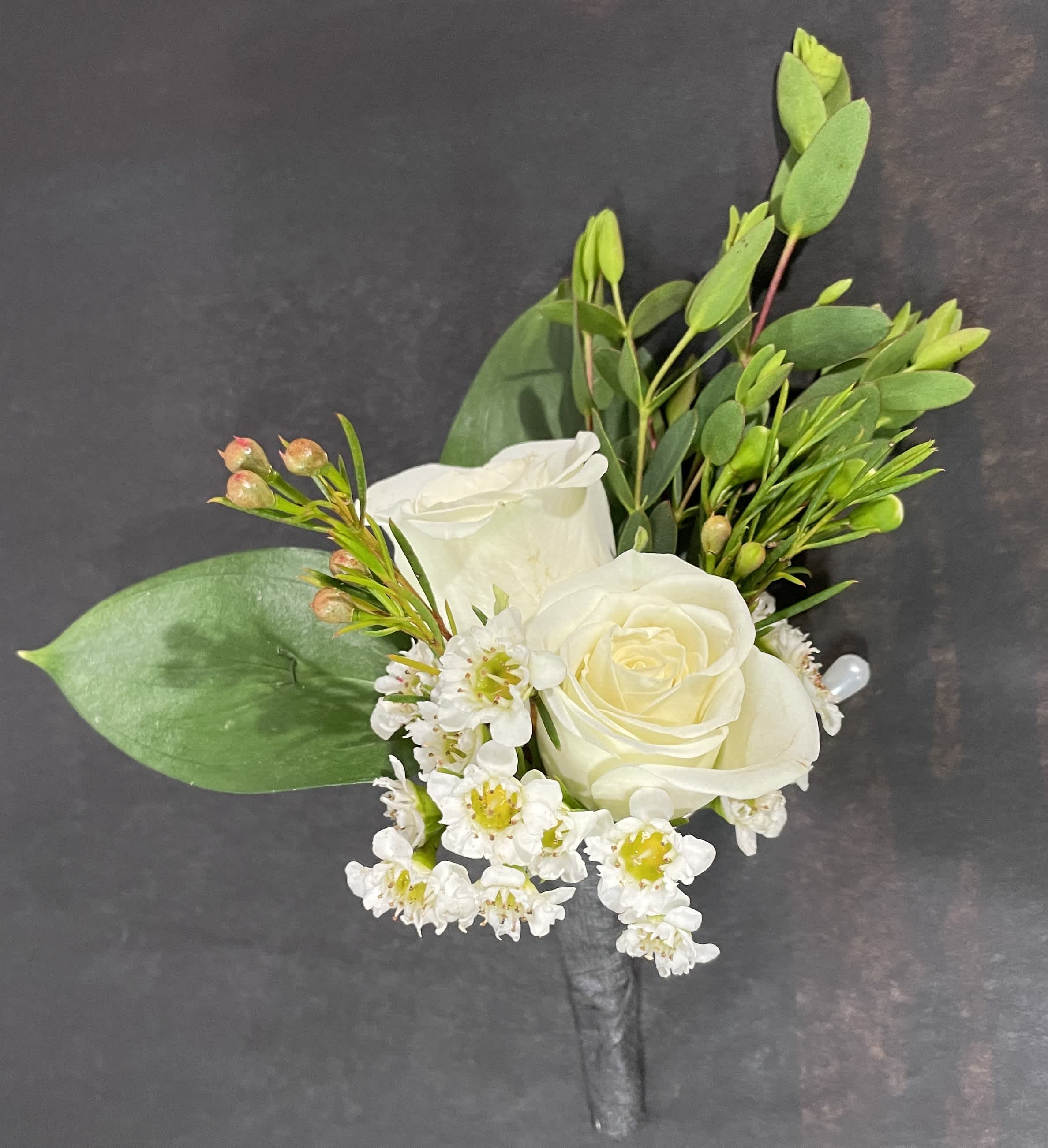 White Rose Boutonniere  by Chandler Flowers - A classic white boutonnière that compliments any suit. A perfect addition for any prom, formal, or wedding event. 