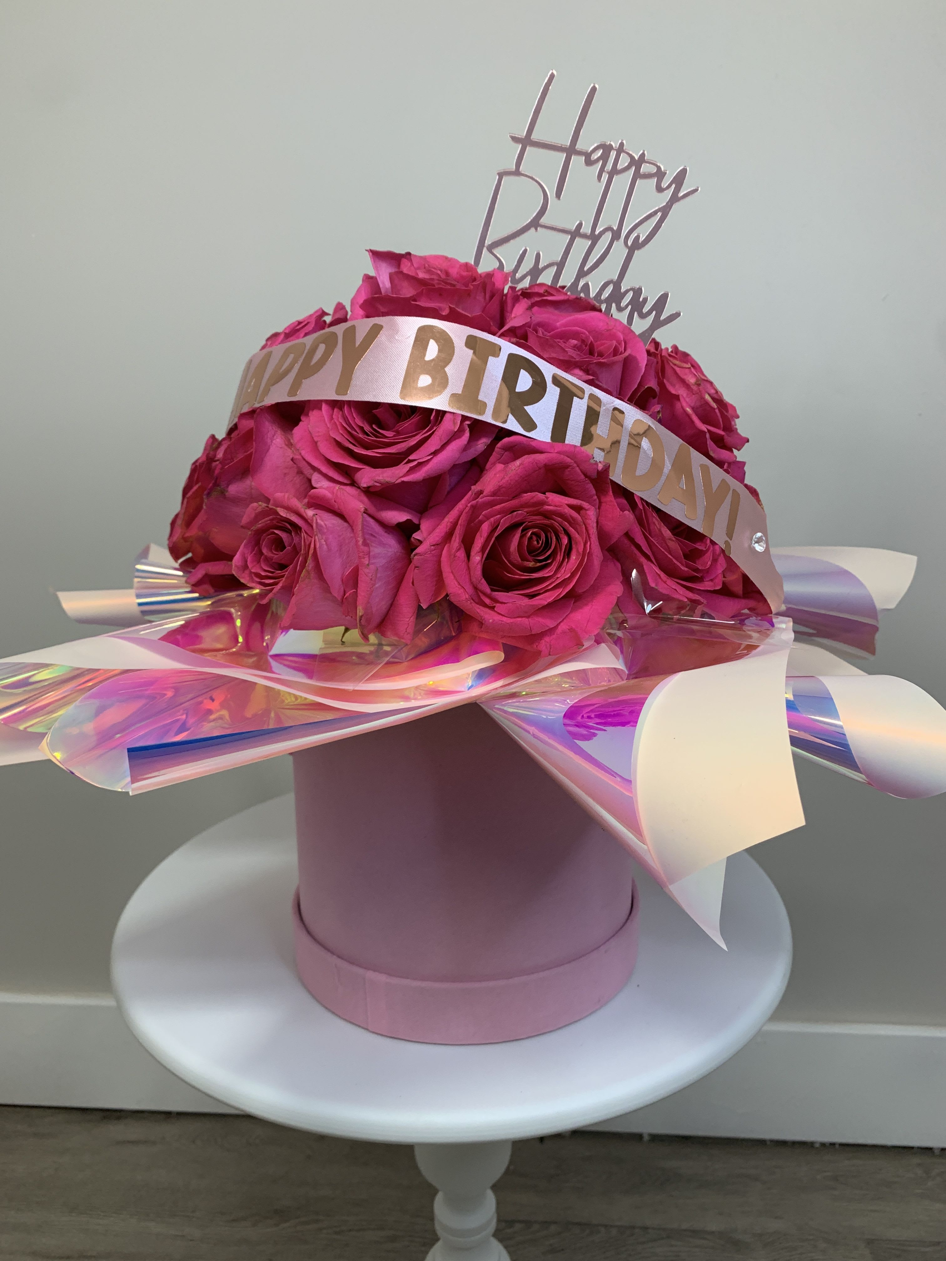 Birthday Cake  - Hot pink roses and pink roses in a pink box with pink holographic paper.  Custom ribbon with your message or Happy Birthday ribbon with a pink candle and a Happy Birthday topper. 