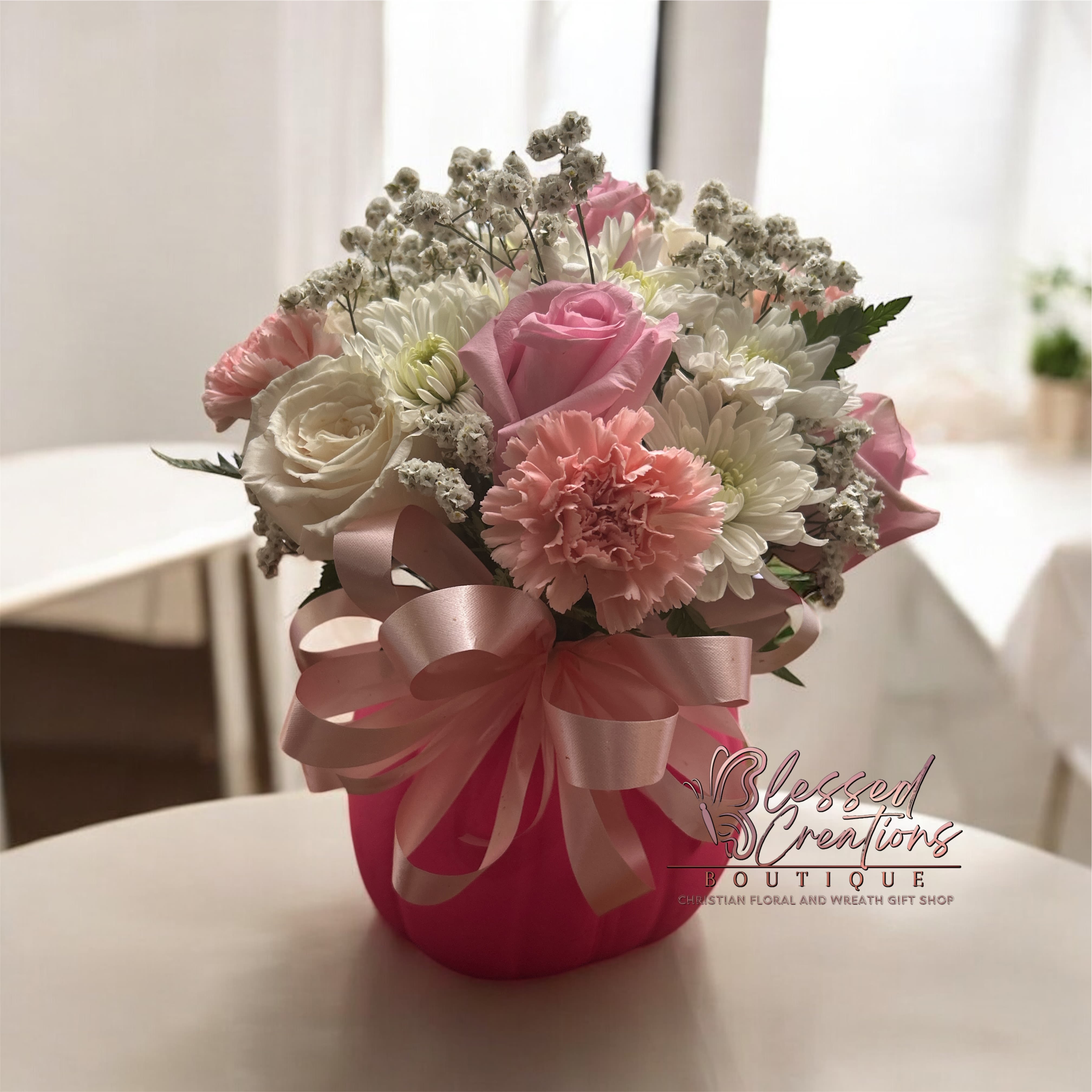Hope Blooms Hope Blooms - Celebrate Breast Cancer Awareness Month with our “Hope Blooms” pink pumpkin flower arrangement — a beautiful mix of pink and white blooms designed to inspire hope and show support. This thoughtful bouquet is perfect for gifting to survivors, warriors, or loved ones to remind them they are not fighting alone. Handcrafted with love by Blessed Creations Boutique, your Christian floral and gift shop in Valdosta, GA. PINK PUMPKINS SELLING QUICKLY!