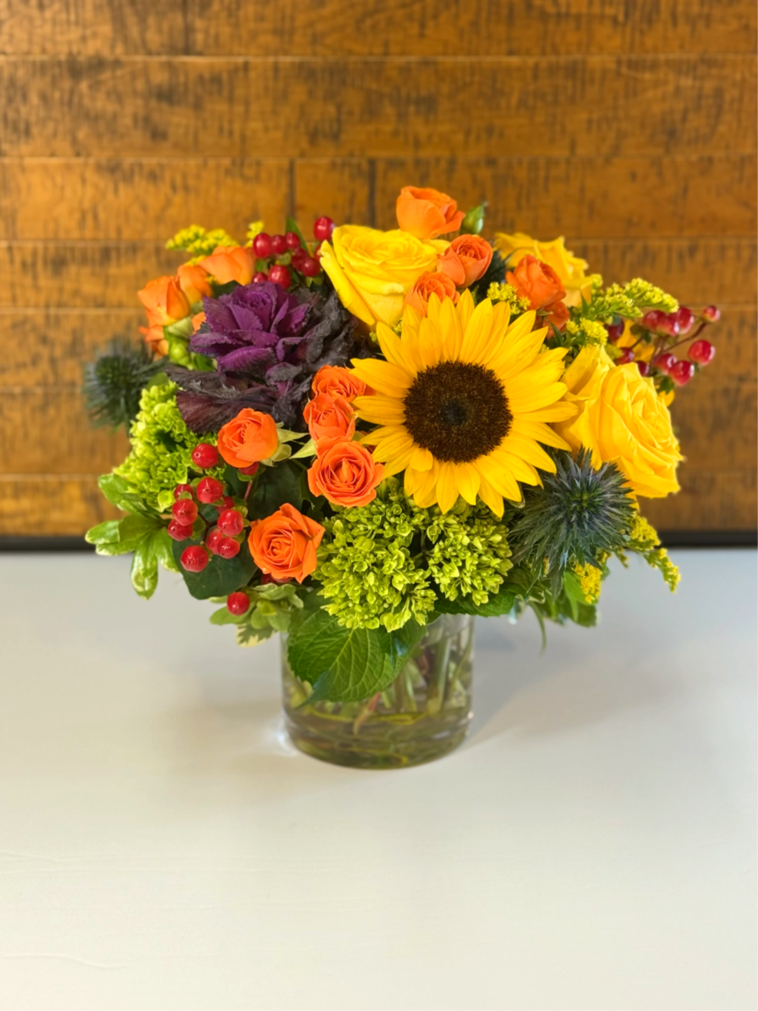 Golden Harvest Golden Harvest - Capturing the majestic beauty of the changing seasons, this golden harvest design features roses in yellow and orange along with hypericum, hydrangeas and sunflowers