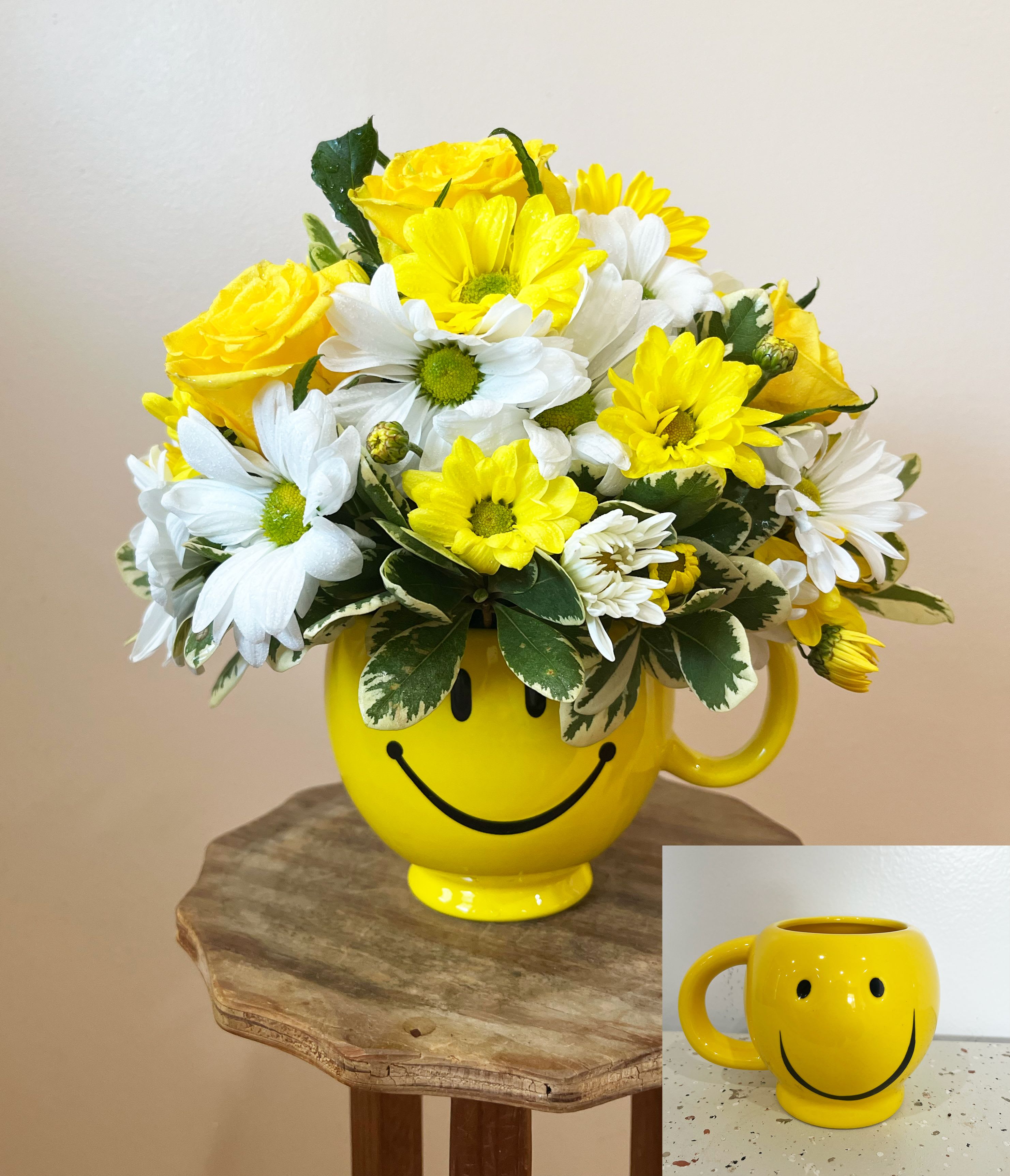 Be Happy Bouquet - Sending someone a smile is as easy and sending them this smiling flower bouquet. The Be Happy Bouquet is the perfect give to turn someone's day around. This yellow smiley face mug is overflowing with seasonal yellow flowers such as daisies and roses, accompanied by white daisies sprinkled in. The best part is that the mug, after a good washing, is reusable, this this really will bring them a smile day after day. Perfect for morning coffee or afternoon tea, the this yellow treat is worth giving. *** Happy Face Design will vary****