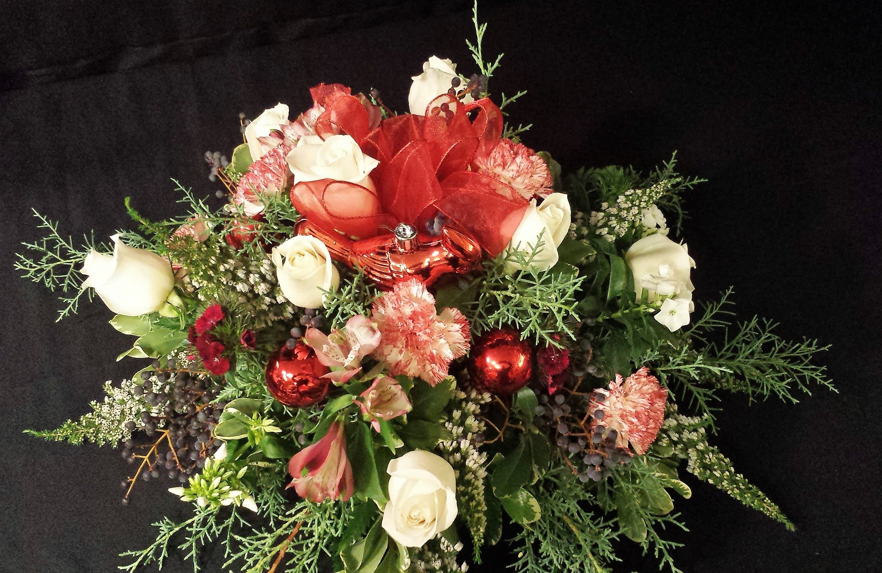 Holiday Rose Centerpiece with Bird Ornament Holiday Rose Centerpiece with Bird Ornament - We will use flowers and/or roses that best fit the season, including berries or other fun accents. Color may vary. Specify color requests when you order at least a week prior. Nice medium size round Centerpiece for a table of up to 7 guests.