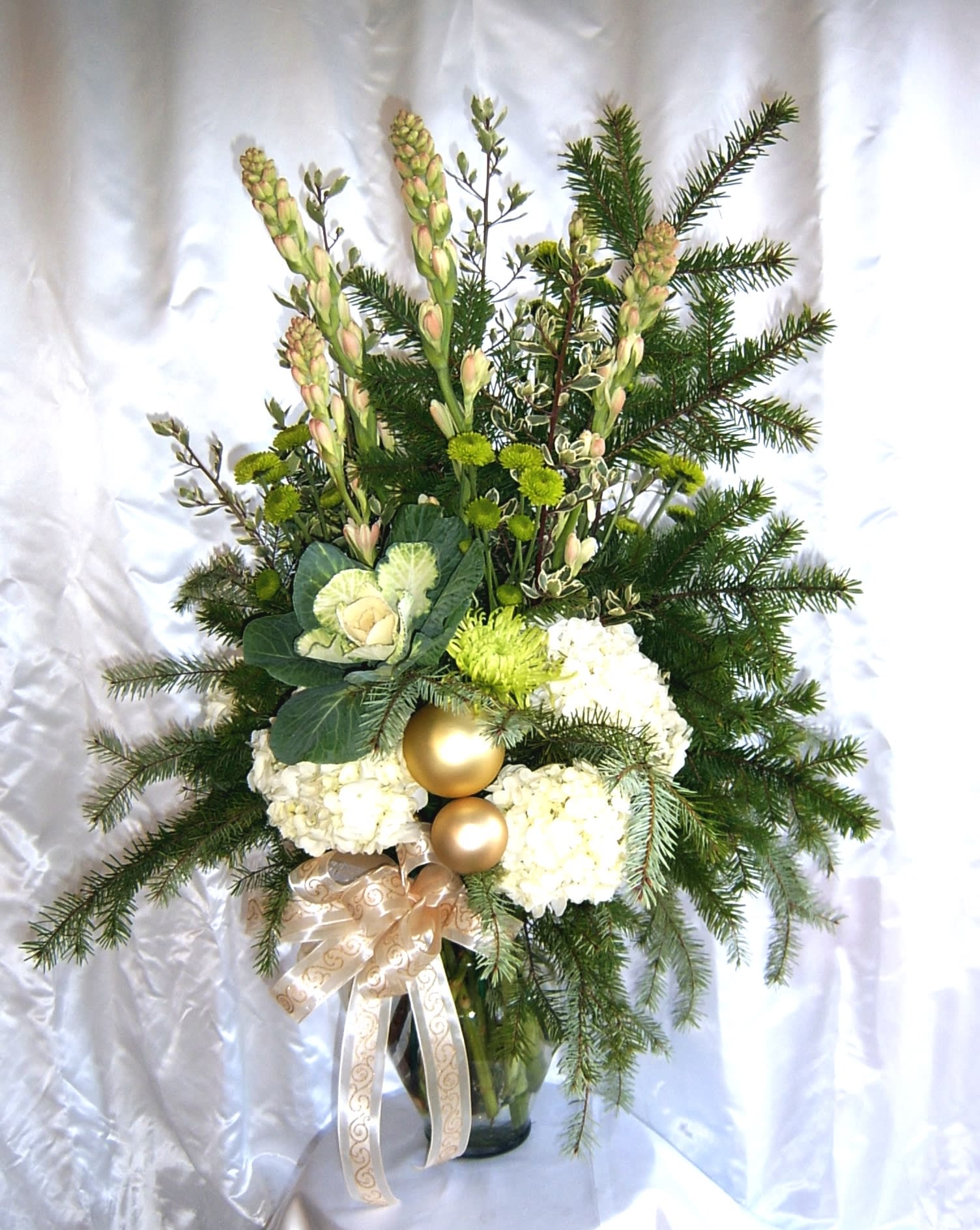Christmas gold and creamy tuberoses Christmas gold and creamy tuberoses - The fragrance of sweet tuberose and noble fir greenery will really lift you into the holidays. Shiny gold ornaments and lime green chrysanthemum flowers accent the beautiful ivory hydrangea.* Please order well in advance. Tuberoses may need longer than a week advance order time.