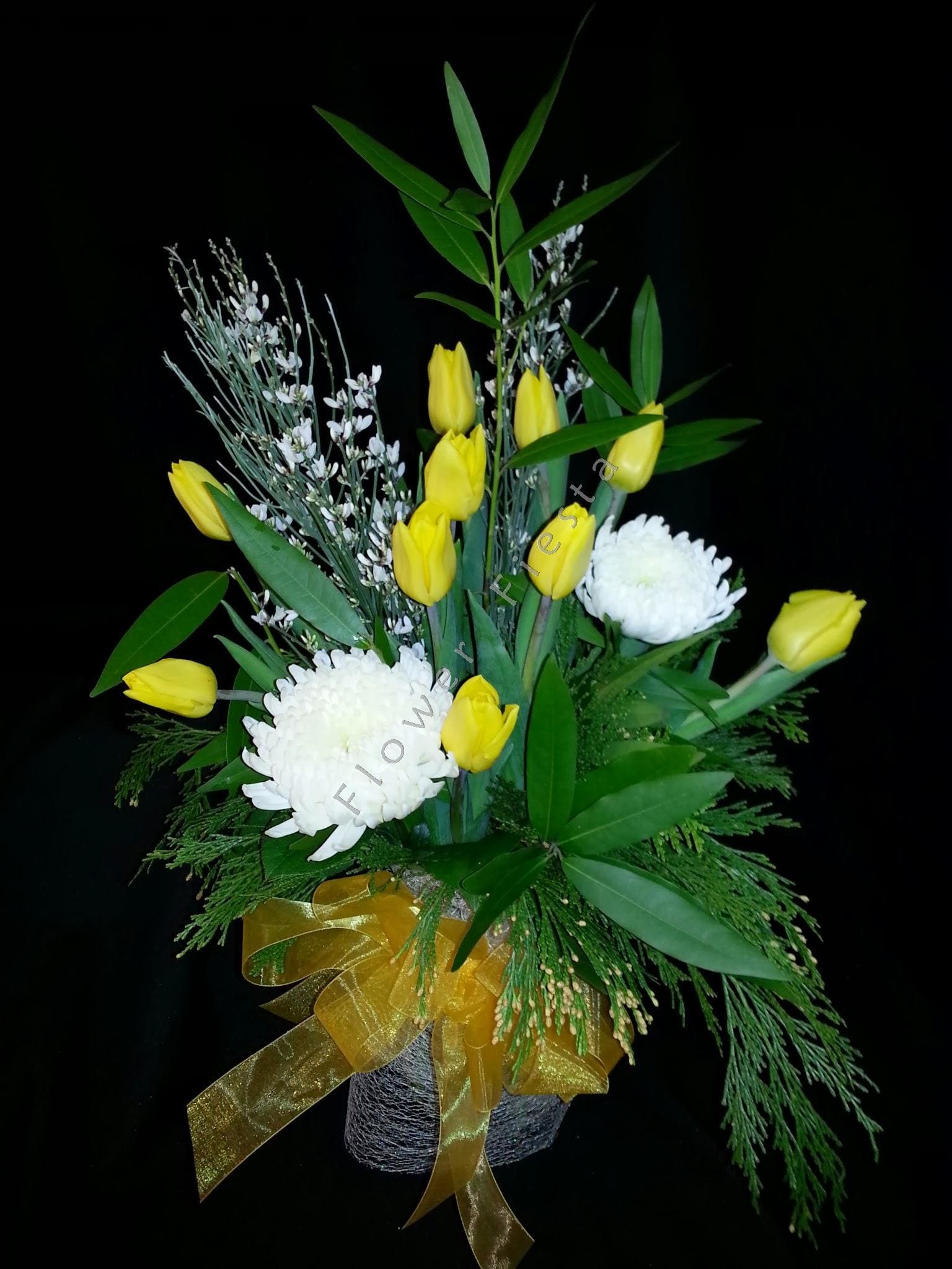 Winter tulip bay leaf centerpiece Winter tulip bay leaf centerpiece - Lightly fragrant display of golden tulips and winter flowers with bay leaves and cedar. Beautiful hostess gift. Festive decor for your next winter gathering. Choose your tulip color when you order in advance.
