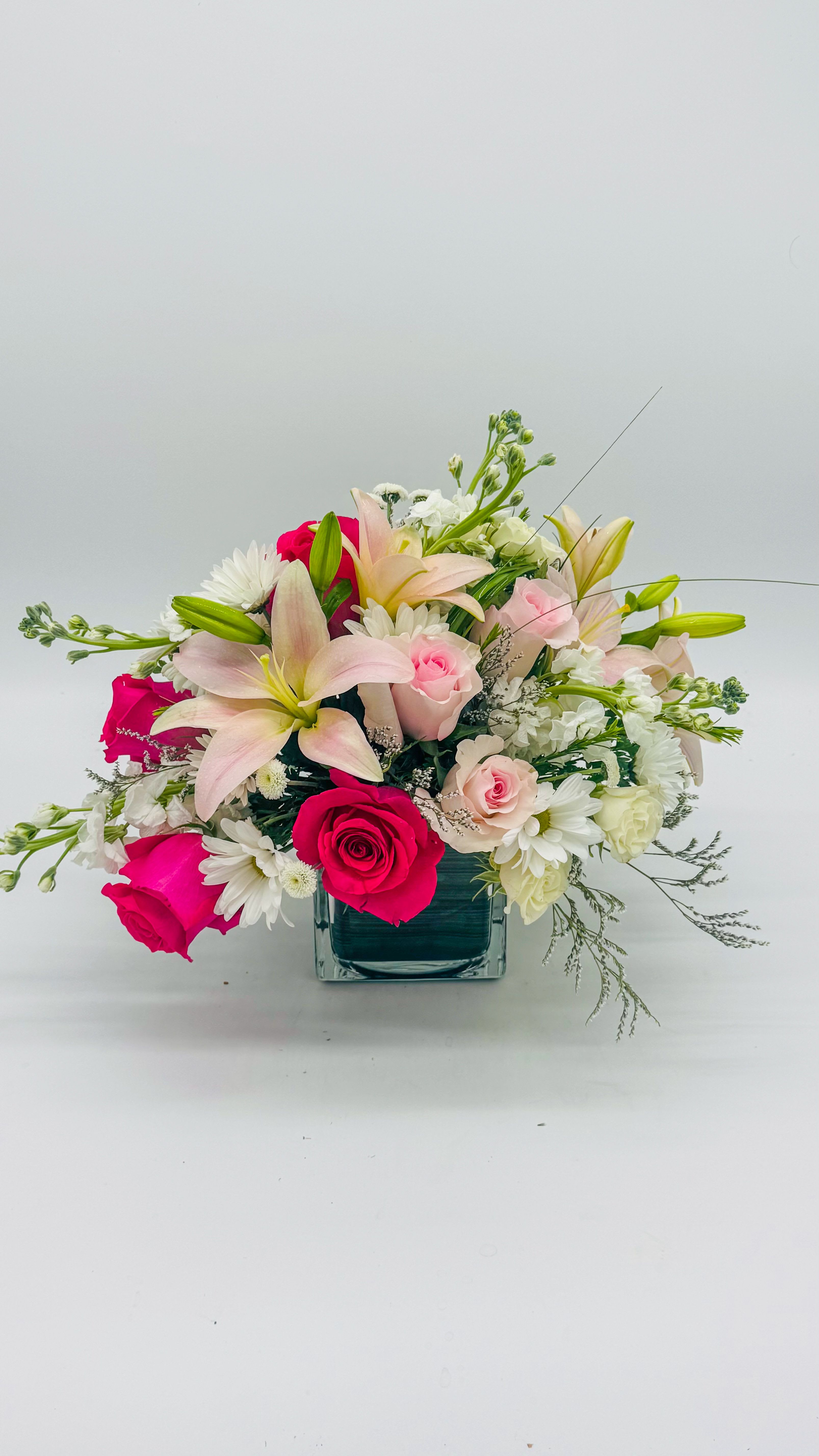 Roselace Roselace - Roselace — a graceful fusion of soft pink roses, airy pink lilies, and pristine white daisies. This bouquet blends timeless romance with modern lightness, creating a centerpiece that feels intimate and uplifting. Velvety roses add warmth, lilies bring height and fragrance, and daisies provide bright contrast. Perfect for weddings, anniversaries, or gifting to brighten any space.