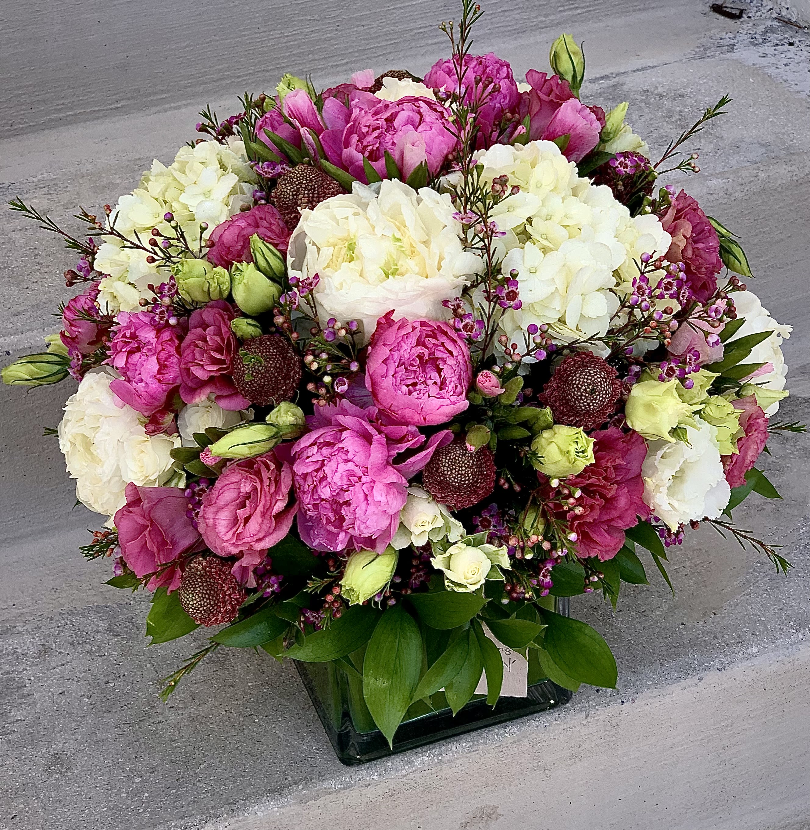white and pink white and pink - This luxury arrangement contains seasonal mixed florals such as roses, hydrangeas, lisianthus and others, beautifully laid out in a square glass vase. PEONIES ONLY IN DELUXE AND PREMIUM VERSION. Handwritten card is included. Send the most beautiful flowers for that special someone. Next day delivery available to Tequesta, Jupiter, Palm Beach Gardens and Palm Beach.