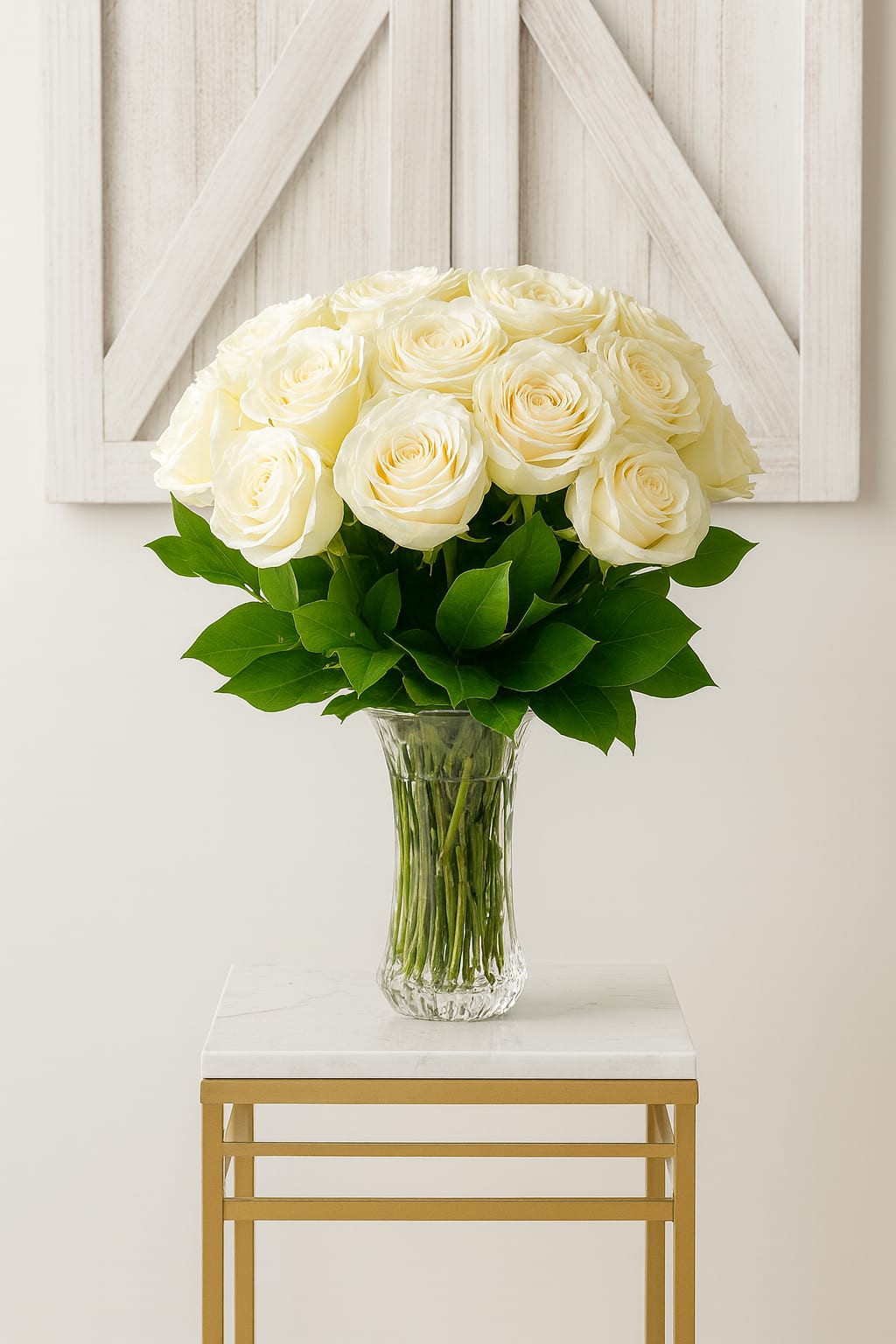 White Horizon - A serene display of premium white roses arranged in a clear glass vase with lush greenery. Symbolizing peace, purity, and remembrance, White Horizon is a timeless choice for sympathy, funerals, or memorial tributes. Its soft elegance brings comfort and light to any setting.