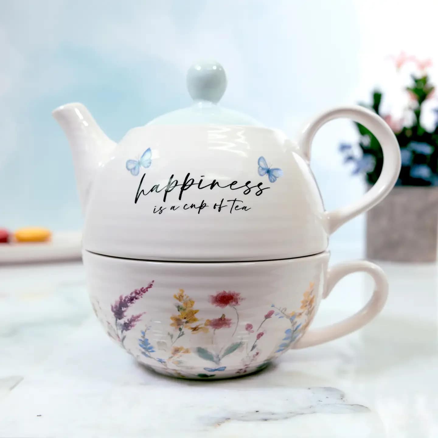 Happiness - Tea For One (14.5 oz Teapot &amp; 10 oz Cup) - 3-piece tea for one set is made from high-quality ceramic. The teacup that sits at the bottom of the stack is 10 oz. The teapot itself is 14.5 oz. vessel. The lid features a small lip to keep it stable on the top. &quot;Happiness is a Cup of Tea&quot; Meadows of Joy Teapot Tea Cup Set has a glossy body and top with a wildflower design decal. Handles on the mug and teapot make for an easy serve-and-pour design. The beautiful floral design wraps around the ribbed textured teacup, excluding the handle and interior of the mug, which is cream. The teapot also features a ribbed texture and is topped off with a pale blue lid. Washing by hand is recommended. Dishwasher and microwave safe. 