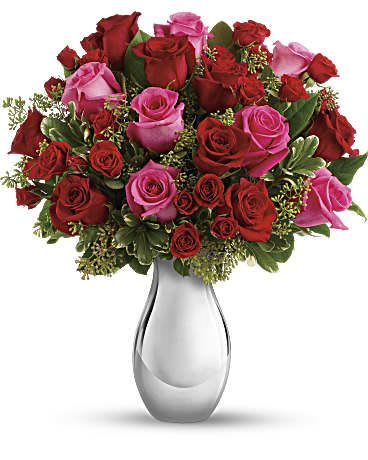 Romance Bouquet with Red Roses - Turn up the heat on a new romance - or a lifelong love affair - with this premium rose bouquet. It features a total of fifteen of our finest red and hot pink roses and is accented with smaller red spray roses and luxuriant greens. It's all artfully arranged in our stunning Silver Reflections vase. This romantic bouquet includes large red and hot pink roses, bountiful red spray roses and greens including seeded eucalyptus and variegated pittosporum. This bouquet is delivered in our exclusive Silver Reflections vase, a metalized ceramic vase with a light pink tone. Orientation: All-Around