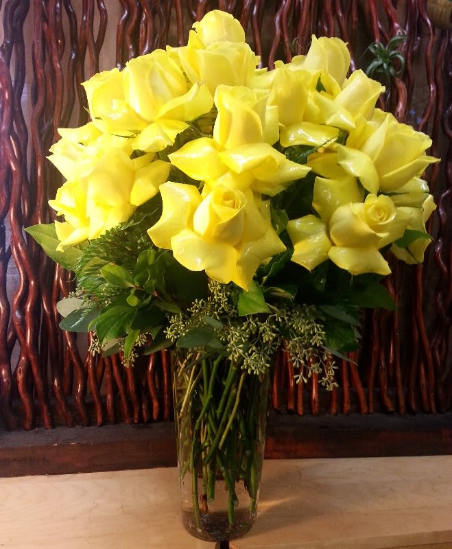 Whisked Away by Roses Whisked Away by Roses - 24 roses beautifully arranged in a tall glass vase adorned with foliage. **Your Choice of Color** Please specify requested color in special instructions and we will do our best to accommodate you based on availability and quality.