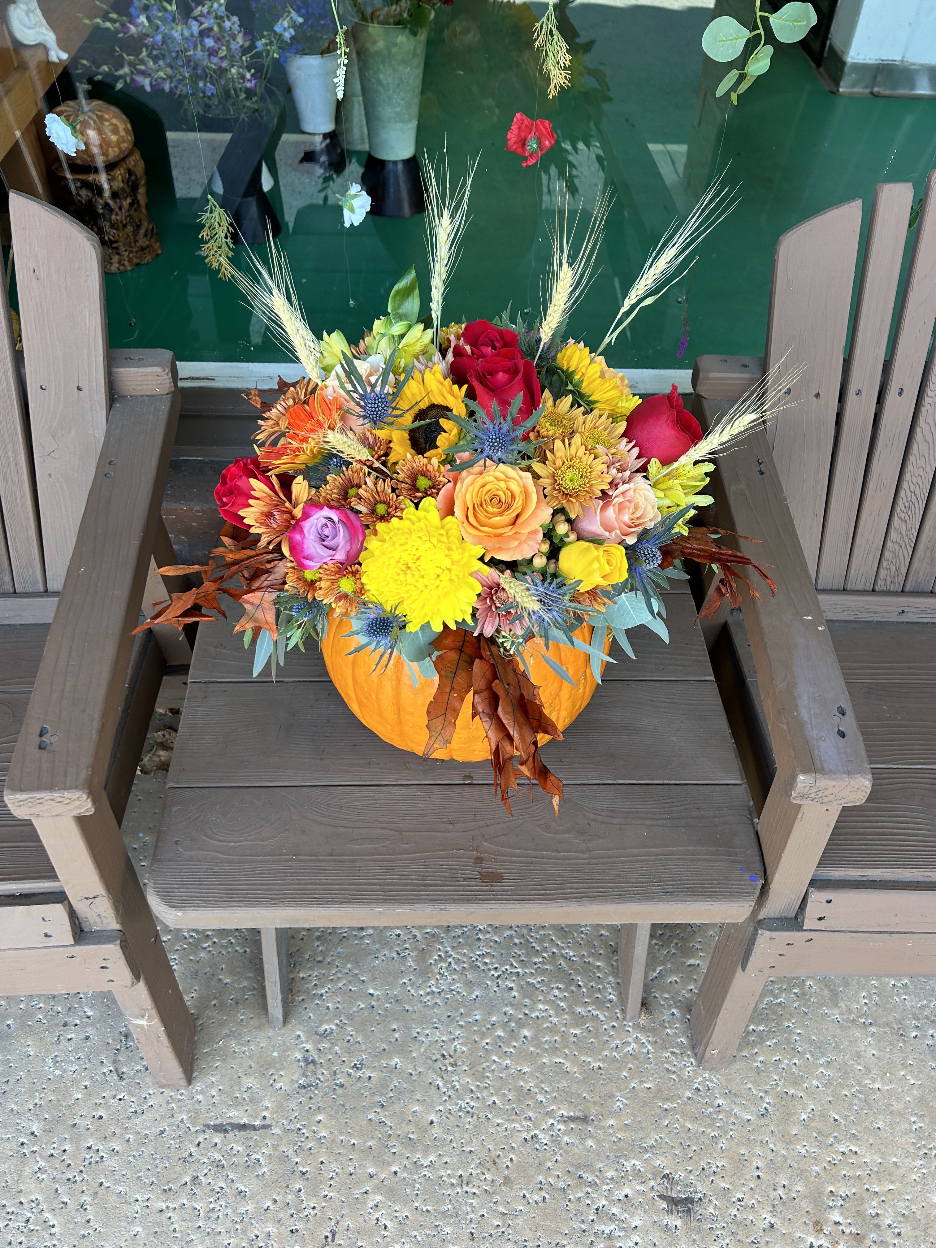 Autumn Stunning Oversized Pumpkin Arrangement  - “A stunning oversized pumpkin centerpiece, overflowing with lush seasonal blooms and greenery. This festive arrangement blends autumn charm with elegant floral design, making it perfect for a front porch display, holiday gathering, or a statement piece indoors. The large pumpkin vessel adds a rustic harvest feel while the vibrant flowers bring warmth, texture, and color to any space.”