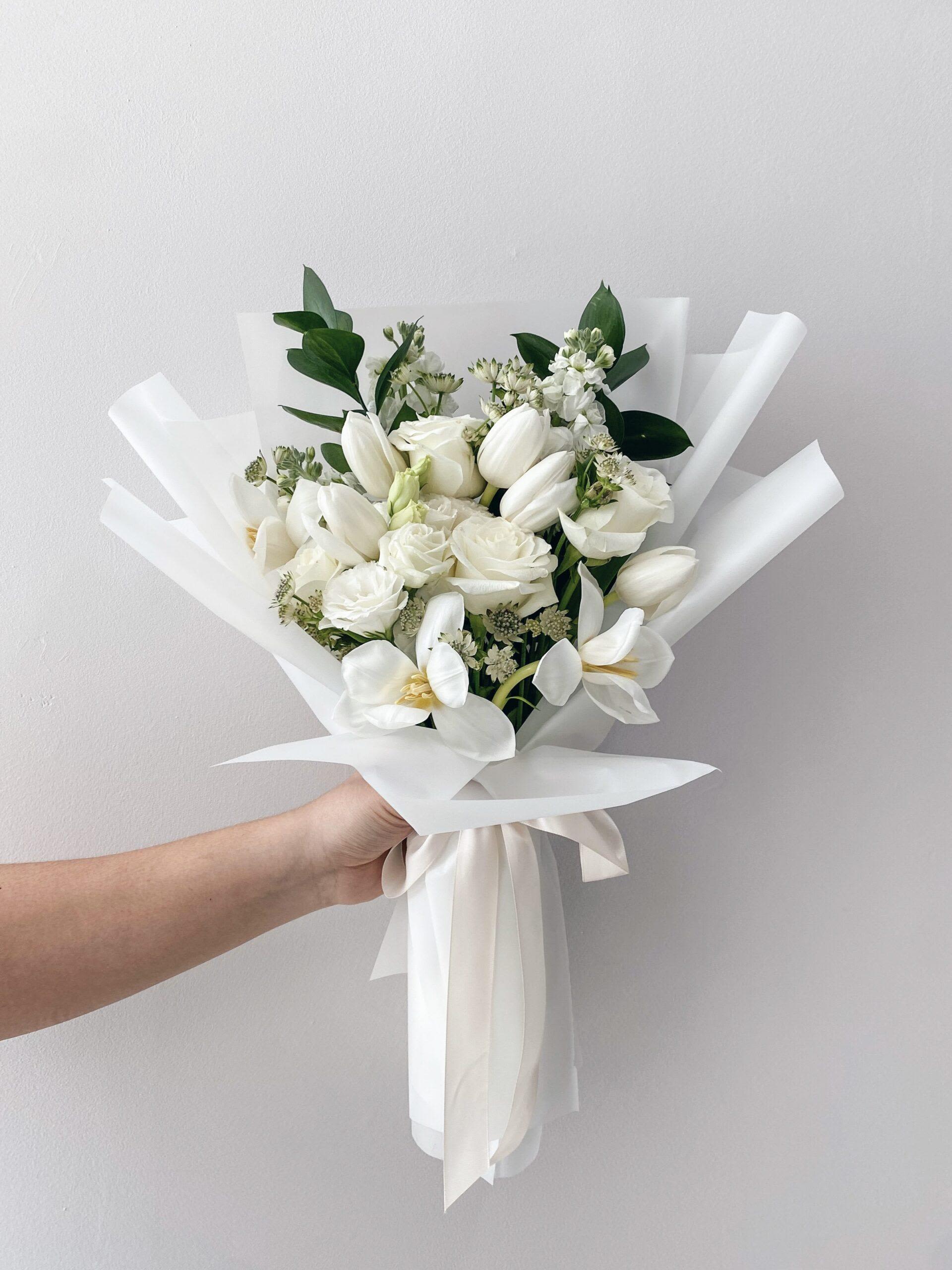 Purity ( With Love) Purity ( With Love) - A stunning hand-tied bouquet featuring soft peach roses, lush hydrangeas in shades of pink, purple, and blue, and fresh eucalyptus. Designed to express joy, elegance, and heartfelt celebration — perfect for birthdays and special milestones.