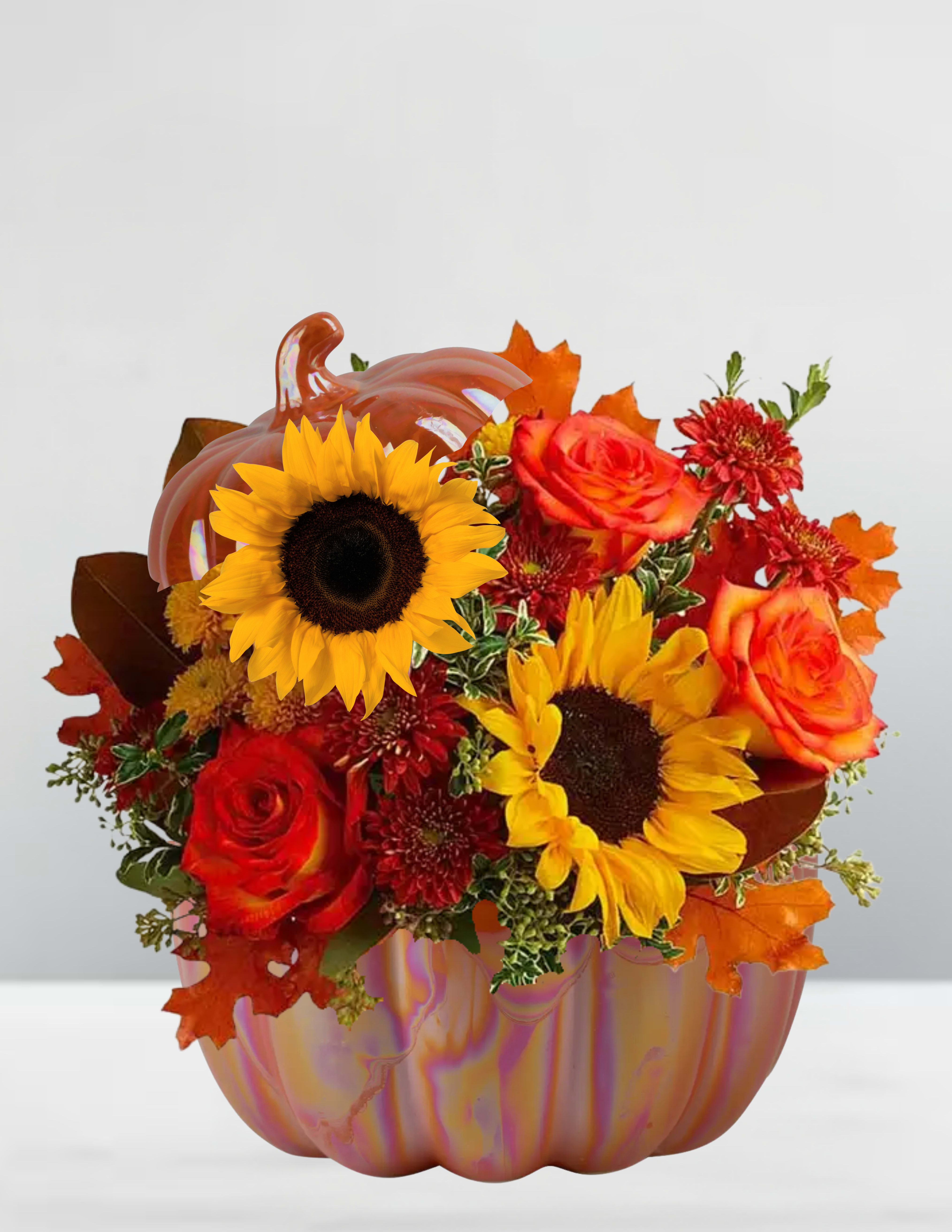 Harvest moon pumpkin  - Harvest Moon Pumpkin A radiant ode to autumn’s golden hour, this enchanting arrangement nestles fiery blooms—sunflowers, amber roses, and crimson mums—within a glossy pumpkin vessel kissed with iridescent hues of pink and copper. Sculpted with a whimsical stem and brimming with seasonal foliage, it captures the magic of twilight skies and crisp October air. Whether gracing a harvest table or gifting a moment of seasonal splendor, Harvest Moon Pumpkin glows with nostalgic charm and festive elegance.