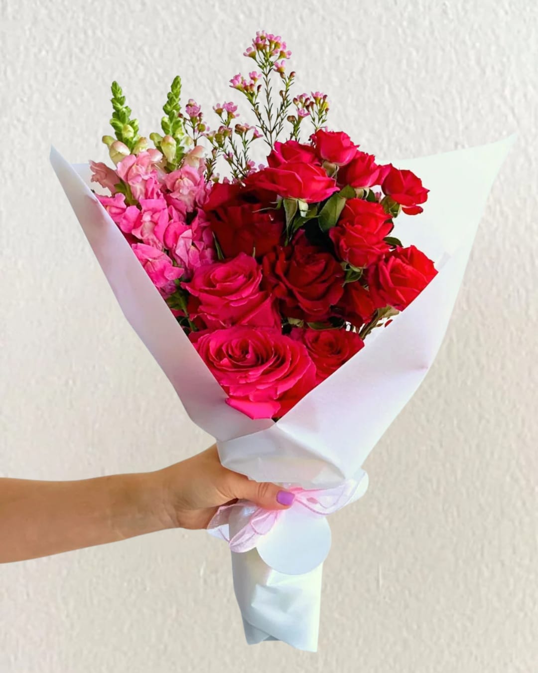 Bold Romance Wrap Bold Romance Wrap - Bold and passionate, this romantic wrapped bouquet features garden roses, snapdragons, and seasonal blooms in deep red and fuchsia. Wrapped in soft white paper and finished with a satin bow, it’s the perfect flower gift for anniversaries, Valentine’s Day, or spontaneous love gestures. Handcrafted by Giuberti Blooms and available for local delivery across Ashland, MA.