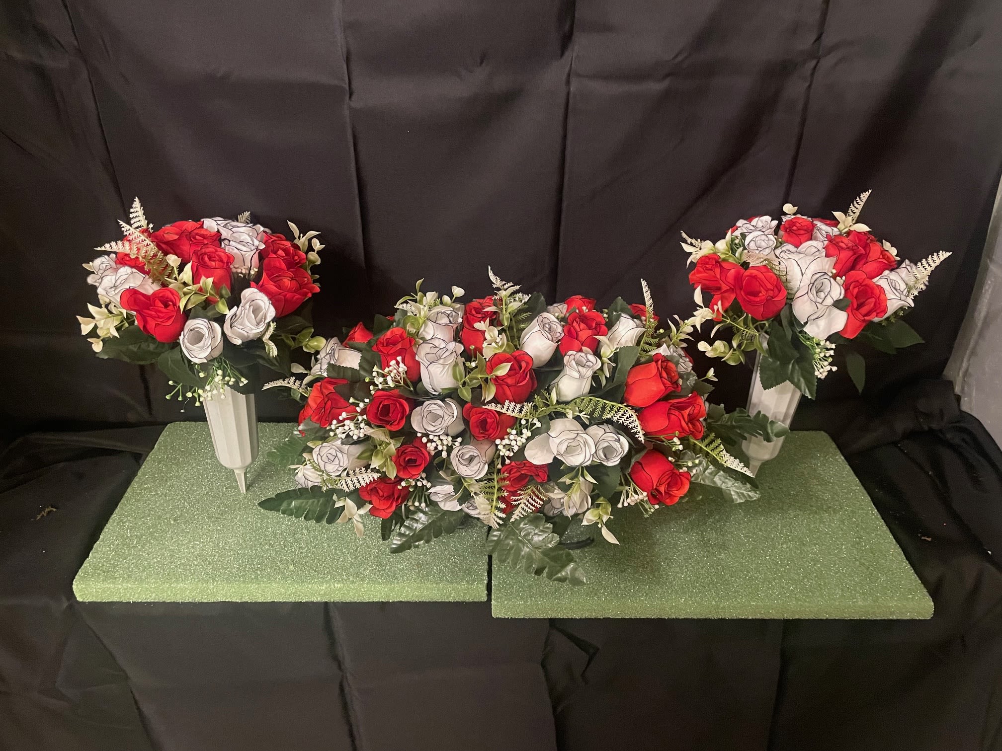 Gravestone saddle set - This arrangement is made to sit atop your loved one's gravestone, as well as two matching vases for the sides. Handmade inhouse of artificial flowers. It's on an adjustable base to make for an easy fit. This Item is for pick-up only. If you'd like it delivered to a cemetery, please call 814.536.0536