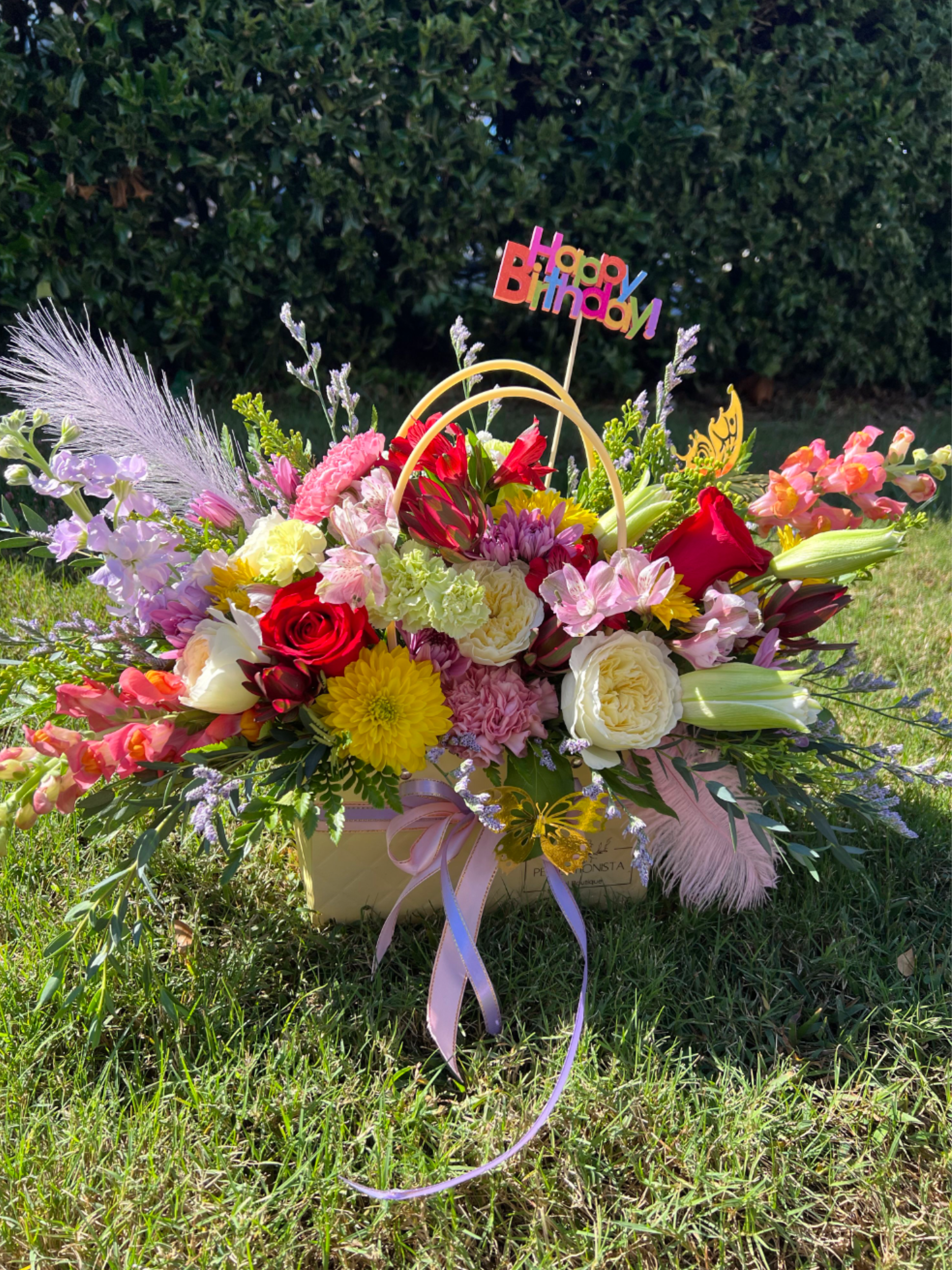 You Make Me Feel So Young You Make Me Feel So Young - Radiant, joyful, and full of personality — this luxury birthday arrangement bursts with color and charm. Designed in an elegant flower bag, it features a vibrant medley of premium blooms including roses, lilies, chrysanthemums, spray roses, stock, alstroemeria, seasonal blooms, and lush greenery.  Touches of lavender sprigs, soft feathers, and delicate butterfly accents add whimsical flair, while a cheerful Happy Birthday topper completes the look. Perfect for those who love bold colors and modern elegance, this piece brings instant celebration energy to any space.  Ideal for: birthdays, milestones, thank-you gifts, or any joyful occasion.