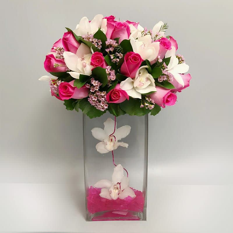 The Life of the Party Flower Sculpture The Life of the Party Flower Sculpture - The Life of the Party Flower Sculpture of fresh blooms with a sweet appeal is set to send your warmest greetings to loved ones, friends, and family near and far. The exquisite pink roses and white cymbidium orchids of this gorgeous flower arrangement have been picked fresh for you to help you celebrate any accession in a big way.  APPROXIMATE SIZE: 20" H x 15" W. Standard bouquet includes 30 stems. Deluxe bouquet includes 35 stems. Premium bouquet includes 40 stems.