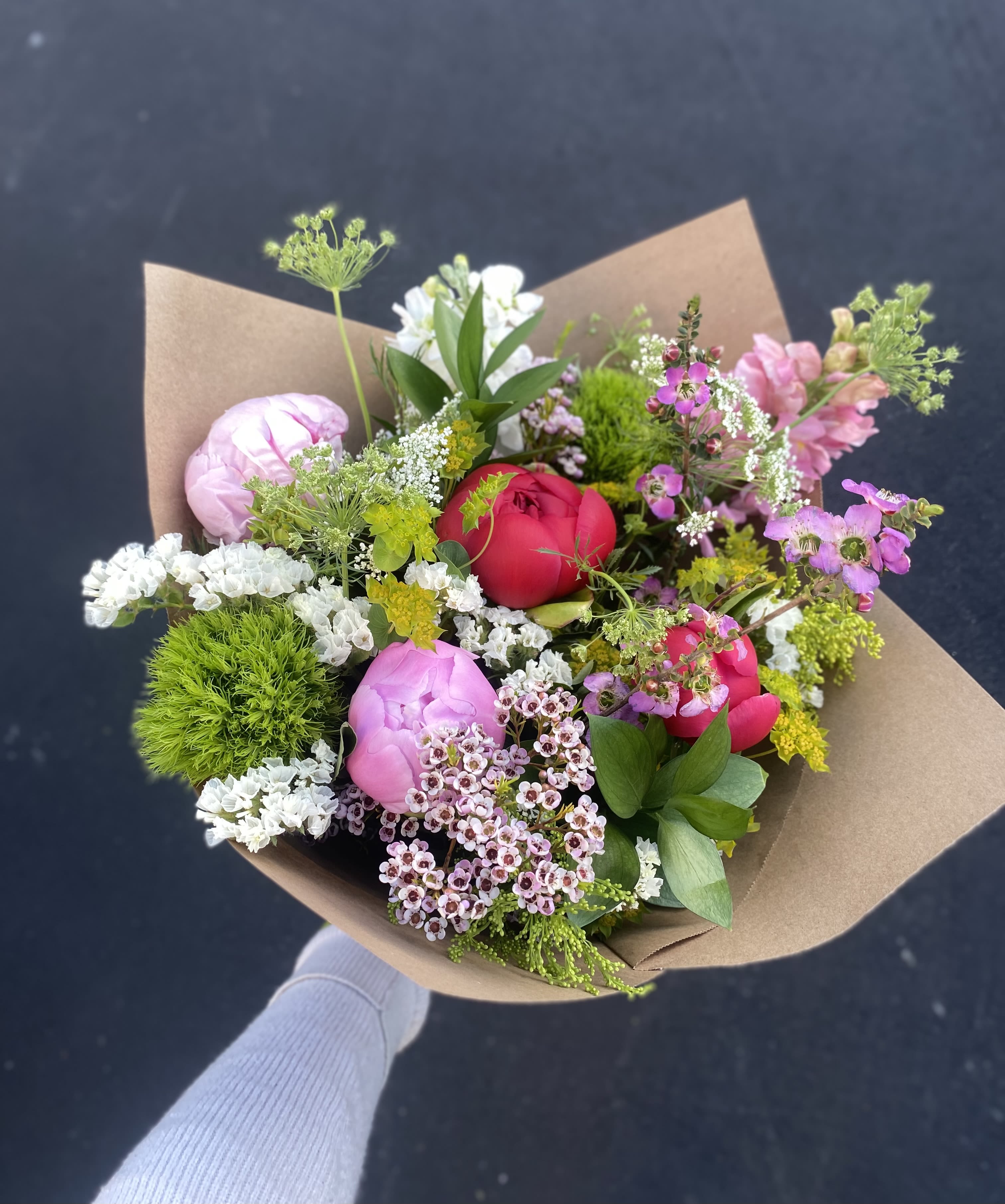 Peony Babe - A sweet, simple bouquet with peonies, soft filler flowers, and greenery, hand-tied in brown paper, perfect for any occasion. Please note that color of peonies may vary.