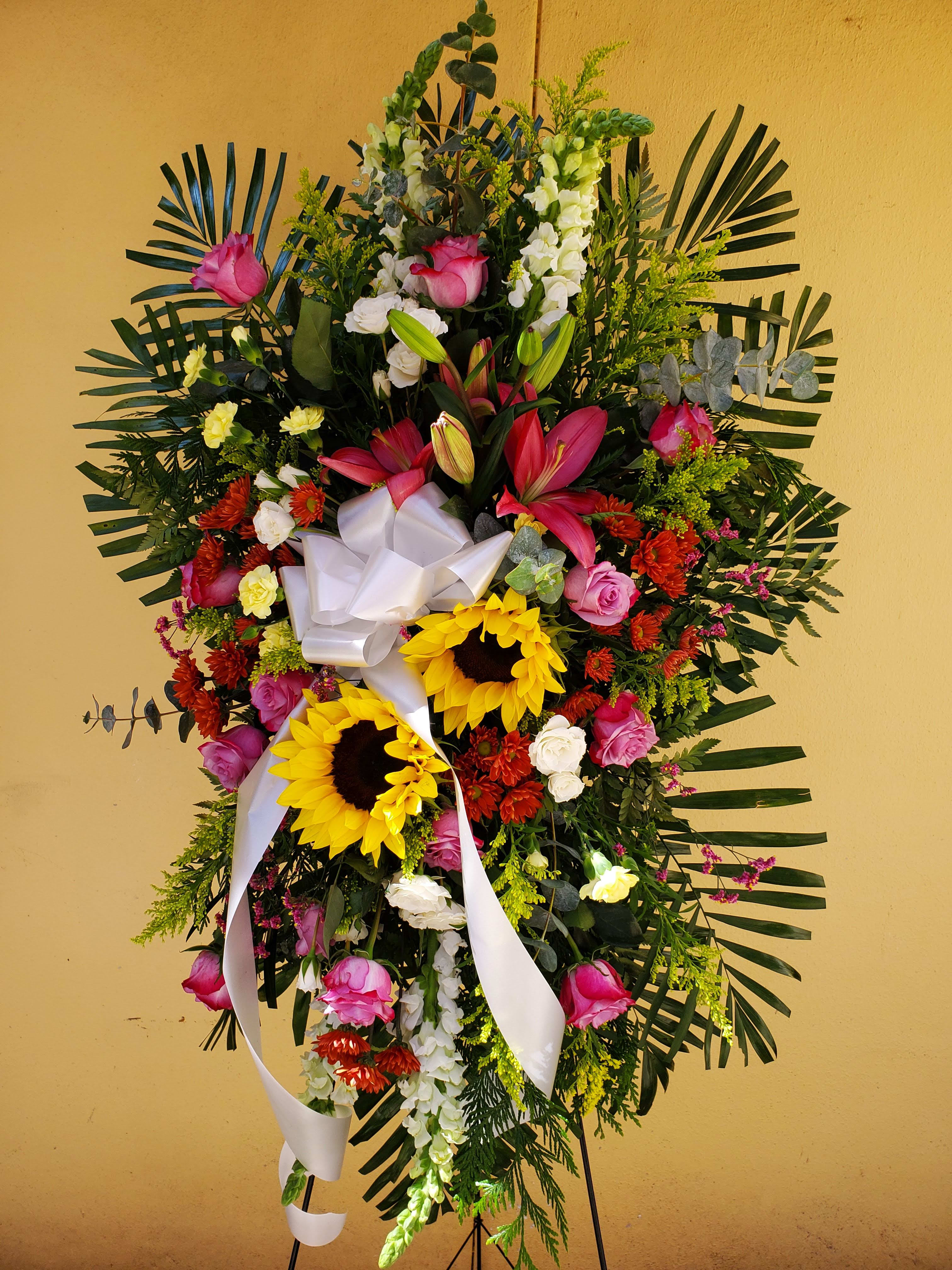 Mixed Spring Funeral Spray - Standing funeral spray with spring flowers such as lilies, sunflowers, roses, and snapdragons.   (Picture depicts a deluxe product; standard &amp; premium size available upon request)