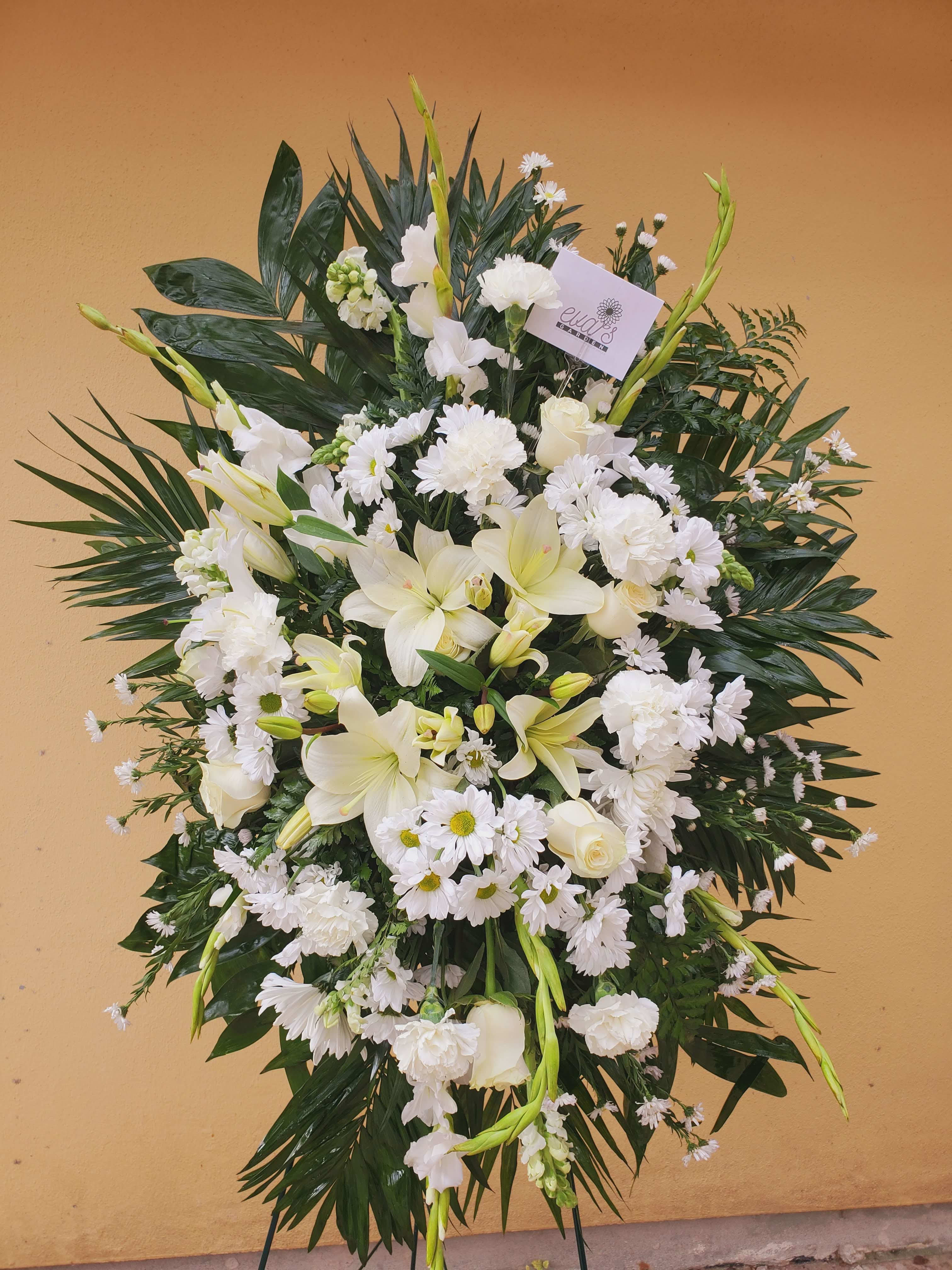 White Funeral Spray - Standing funeral spray with white lilies, gladiolus, daisies, montecasino, carnations, roses, and snapdragons.   (Picture depicts a deluxe product; standard &amp; premium size available upon request)