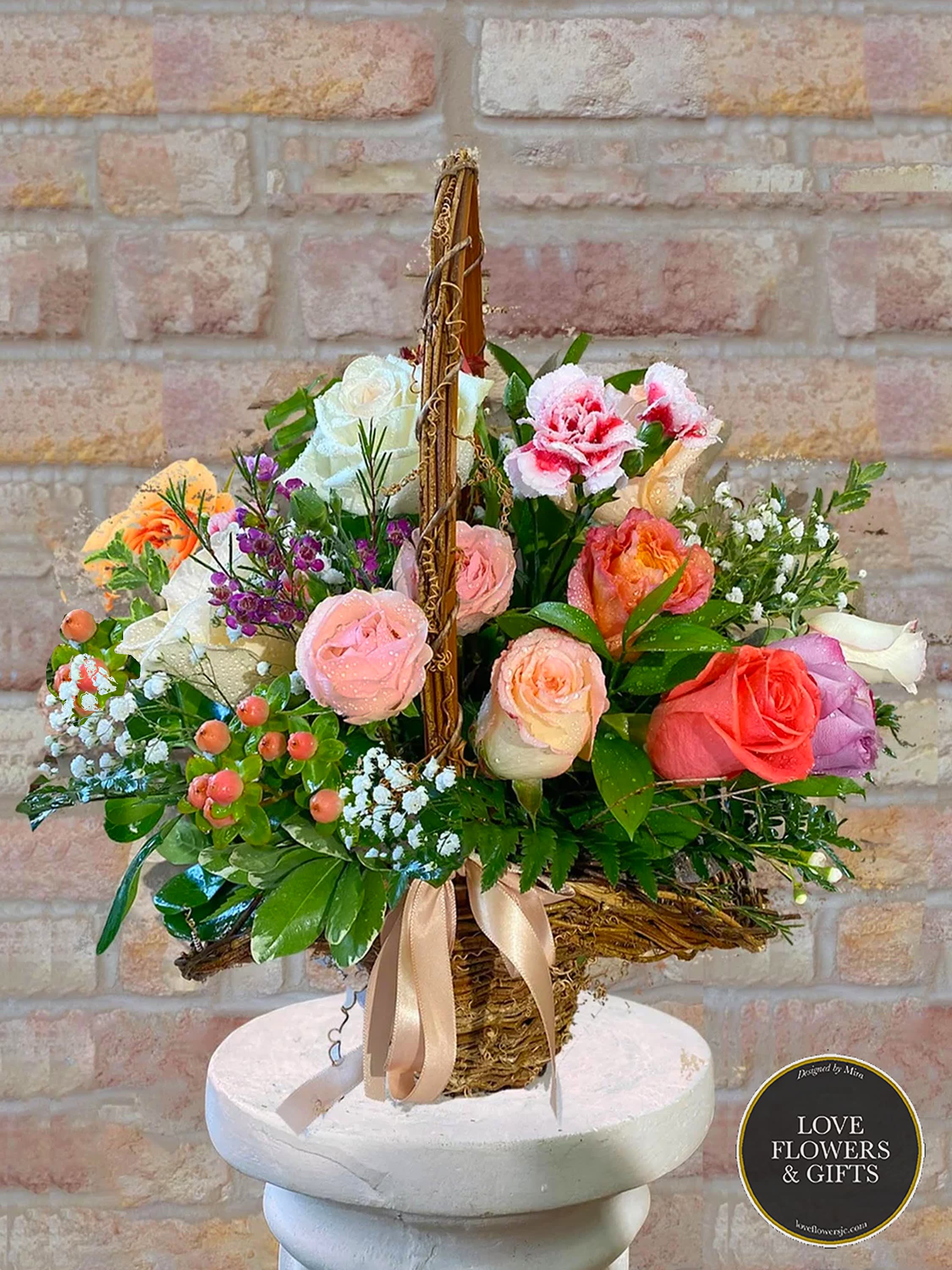 Sweet Rose Basket Sweet Rose Basket - One of our shop's bestsellers! A beautifully soft and spring-like basket arrangement, tied with a satin ribbon. Made with roses, carnations, baby's breath in a bed of fresh greenery. Great for all kinds of occasions and beautiful people :)
