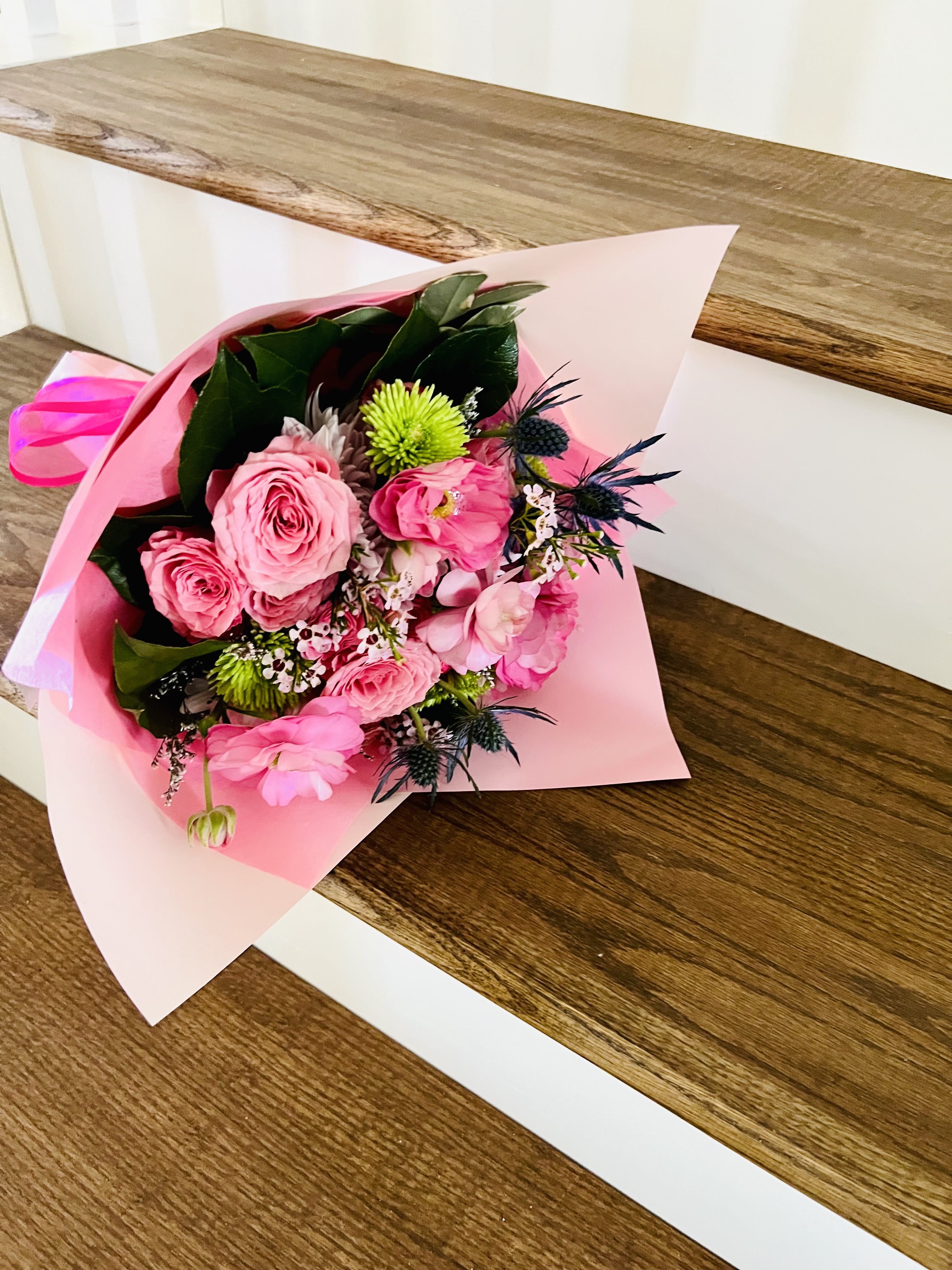 Everyday Elegance - A designer’s choice wrapped bouquet featuring 5 radiant roses paired with premium seasonal accents and lush foliage, finished with a charming bow. Thoughtfully crafted to bring a touch of joy and sophistication to everyday moments. Perfect as a cheerful pick-me-up or a simple gesture of appreciation. Each bouquet is uniquely styled with the freshest blooms of the season.  For same day delivery and Free Delivery Options Text or Call  832-973-1376.