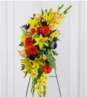 The  Heaven Ligh Standing Spray The  Heaven Ligh Standing Spray - The  Heaven's Light Standing Spray is a bright and brilliant tribute that offers warmth and hope. Sunny yellow gladiolus and Asiatic lilies are offset by crème de la crème roses, orange gerbera daisies, purple lisianthus, green button poms and lush greens. Accented wth a designer sea mist green wired taffeta ribbon and displayed on a wire easel, this beautiful standing spray will be a ray of light to honor the deceased and bring comfort to family and friends. Approximately 48"H x 16"W. Your purchase includes a complimentary personalized gift message.