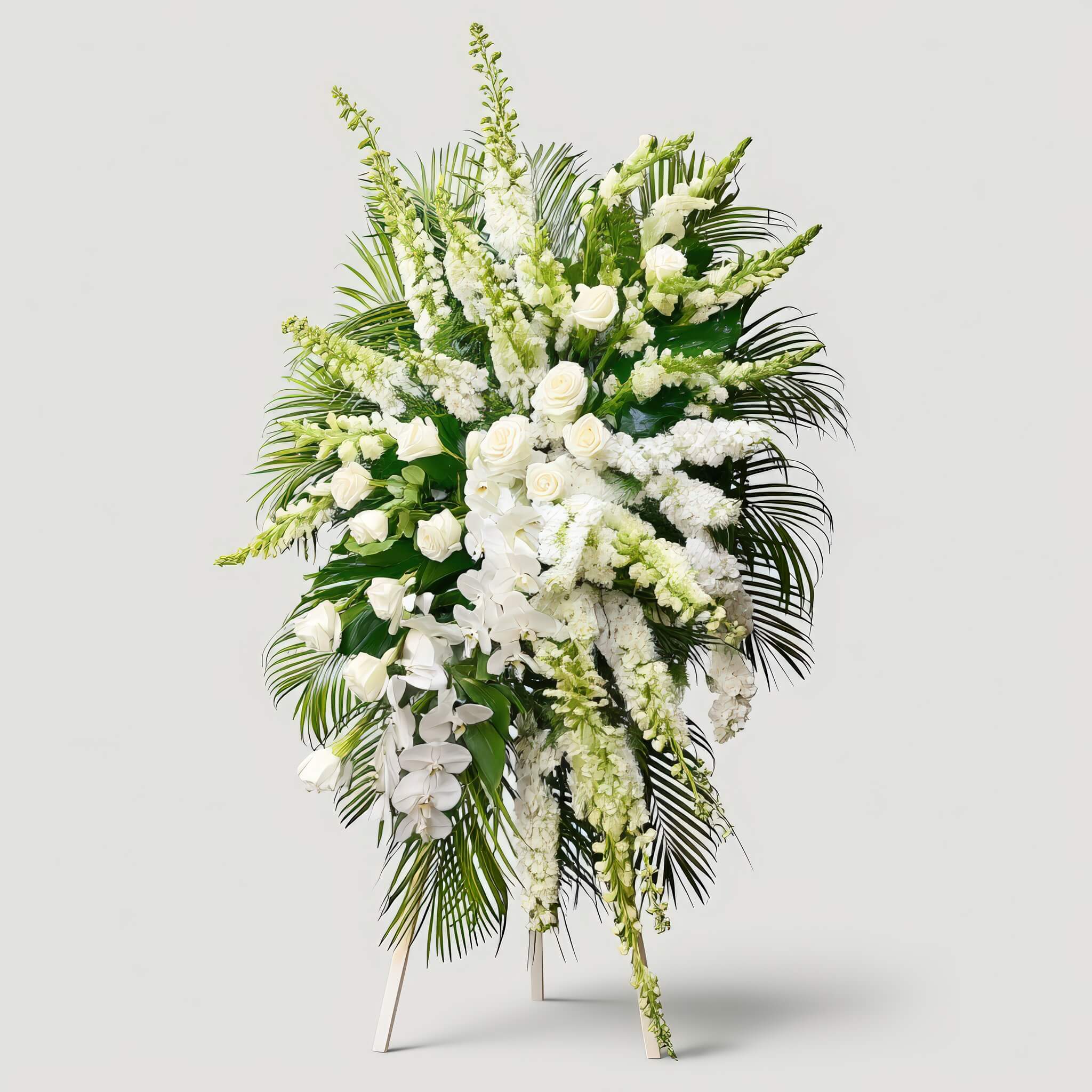 Peaceful Horizon Peaceful Horizon - A stunning expression of remembrance and peace, this all-white standing spray features cascading orchids, graceful snapdragons, and classic roses—elevated by bold tropical foliage for a dignified farewell.