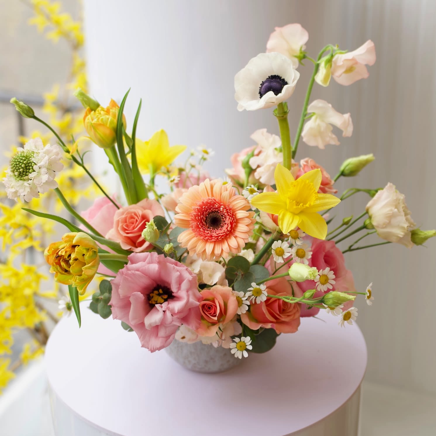 Sweet Siena - Let our expert florists craft a one-of-a-kind arrangement using the freshest blooms available on the day of your order. Each creation is unique and tailored with care, ensuring a stunning and seasonal design. The arrangement comes in a short vase.  ***Please note: photos are examples of our work and serve as inspiration only—your arrangement will be a surprise, beautifully customized just for you!  Right now you can expect roses, ranunculus, lisianthus, calla lilies and greens.