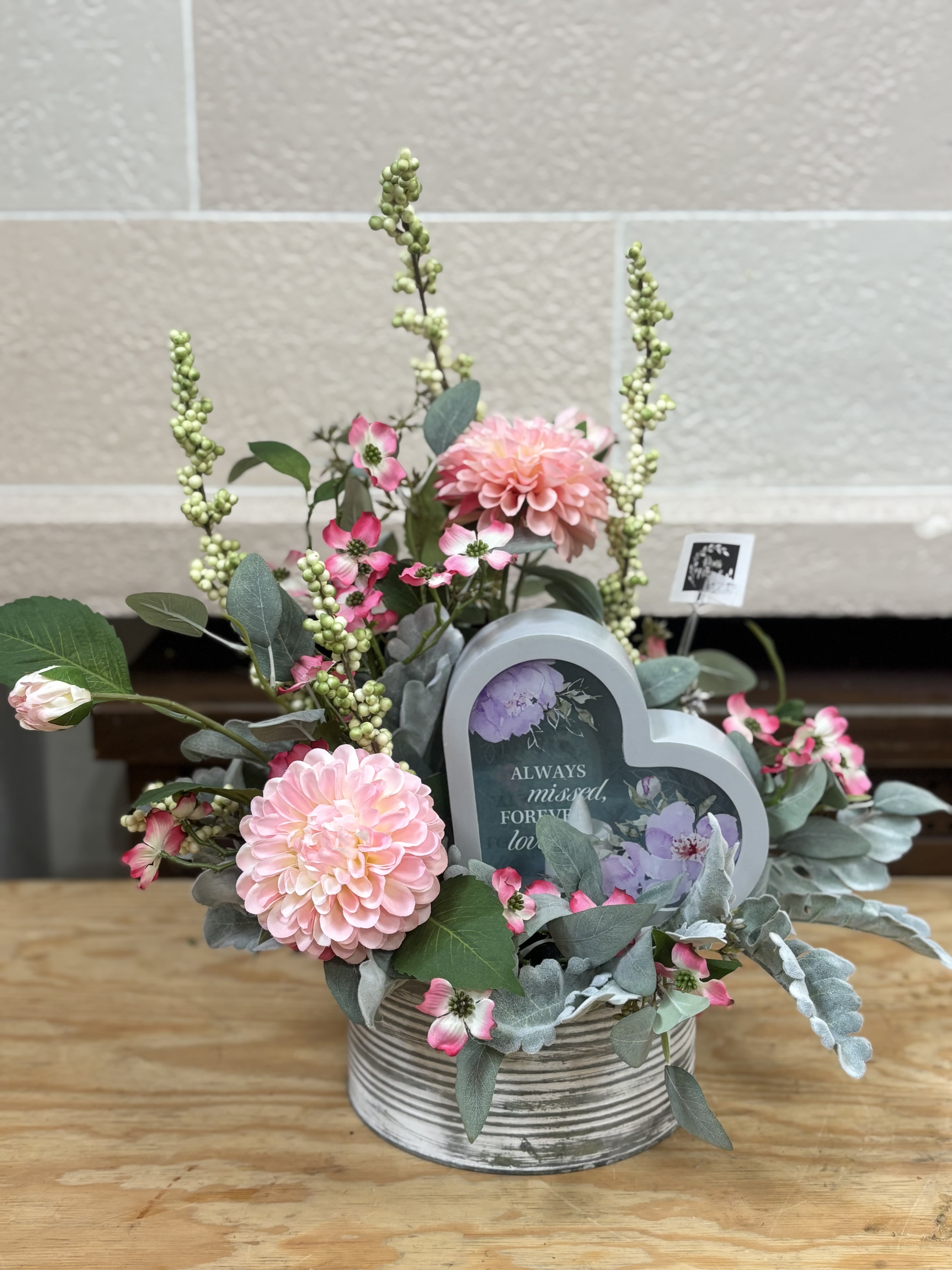 Artificial Sympathy Tin - An artificial arrangement in a tin highlighting a candle lit heart.  Text on Heart Reads: &quot;Always missed, forever loved&quot;