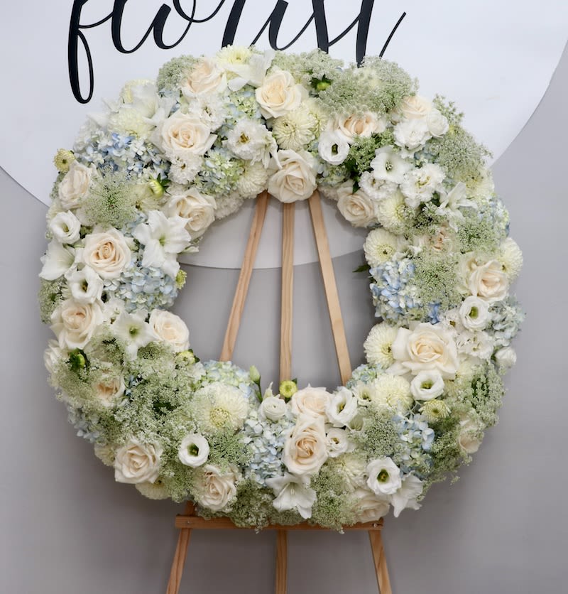 Soft Blues Hues  - This wreath mixes together softly blue hydrangeas with roses and lisianthus, paired with seasonal greenery. 