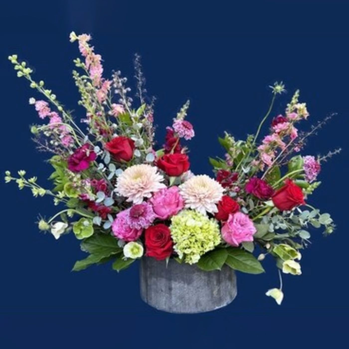 Garden Amor - This arrangement is perfect for any garden lover, offering a delightful mix of everything! Larksup, roses, snaps, scabiosa, carnations, mums hellabor and green hydrangea fill this out beautifully.