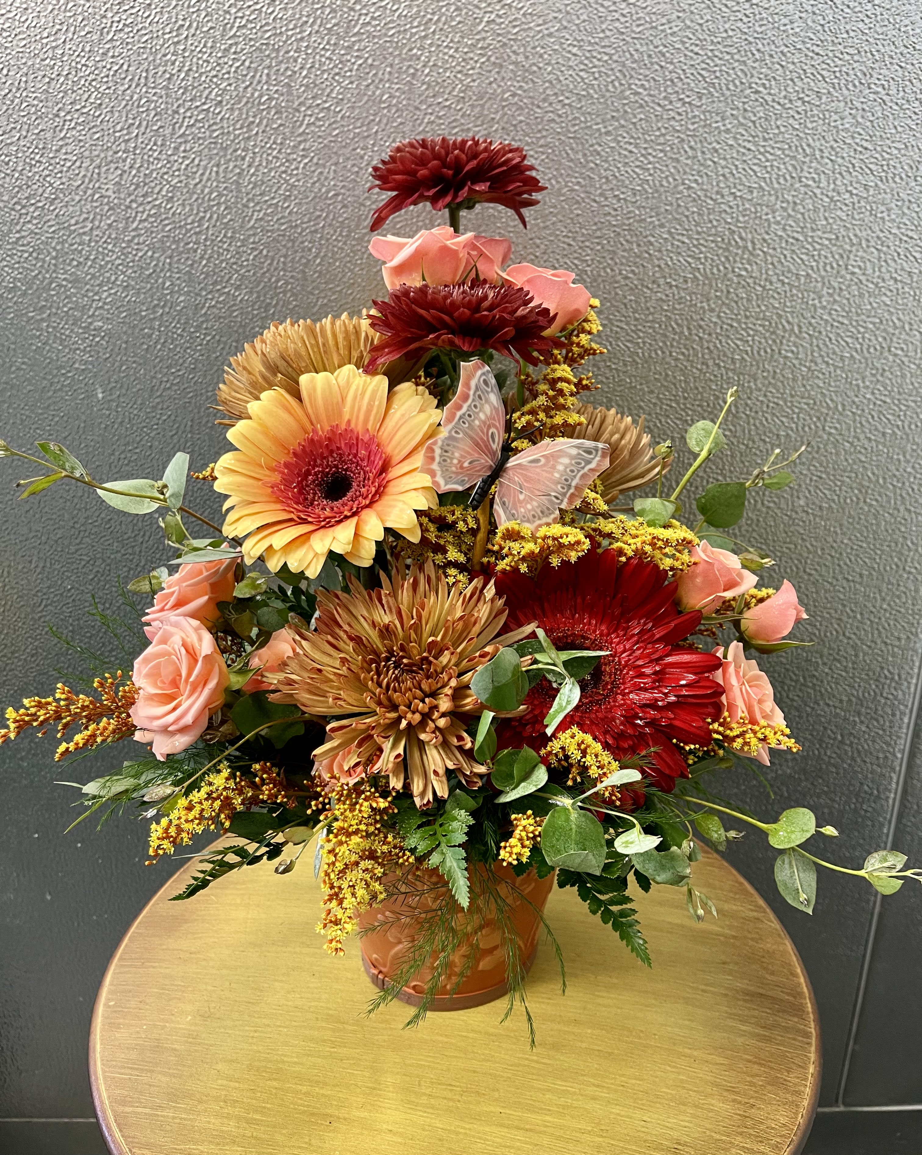 Vesta Vesta - Autumns most beautiful hues come together in a keepsake pot embossed with acorn leaves. Vesta is an excellent gift for any occasion. Birthday, Get Well, Congratulations, or simply Just because! (Flower colors & pot will vary. All designs are arranged as similar as possible. We promise to keep the same color, style, and overall theme with what Mother Nature generously blesses us with)