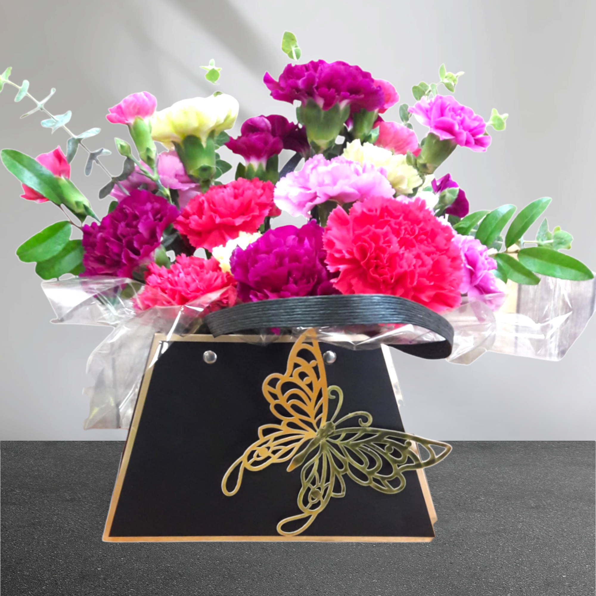 Purse Full of Carnations - One-Of-A-Kind Purse filled to the brim with a plethora of colored carnations!  Please Note: This Purse is not a keepsake!  Choose Premium For A Purse Full Of Roses