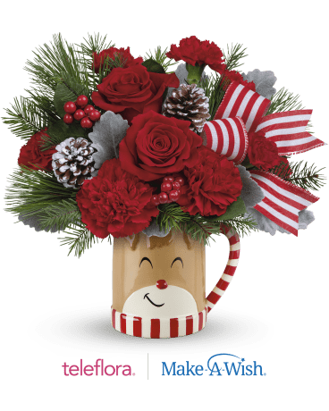 REINDEER WISHES REINDEER WISHES - RED ROSES AND CARNATIONS WITH CHRISTMAS GREENS, BERIES AND RIBBON IN A LARGE KEEPSAKE MUG