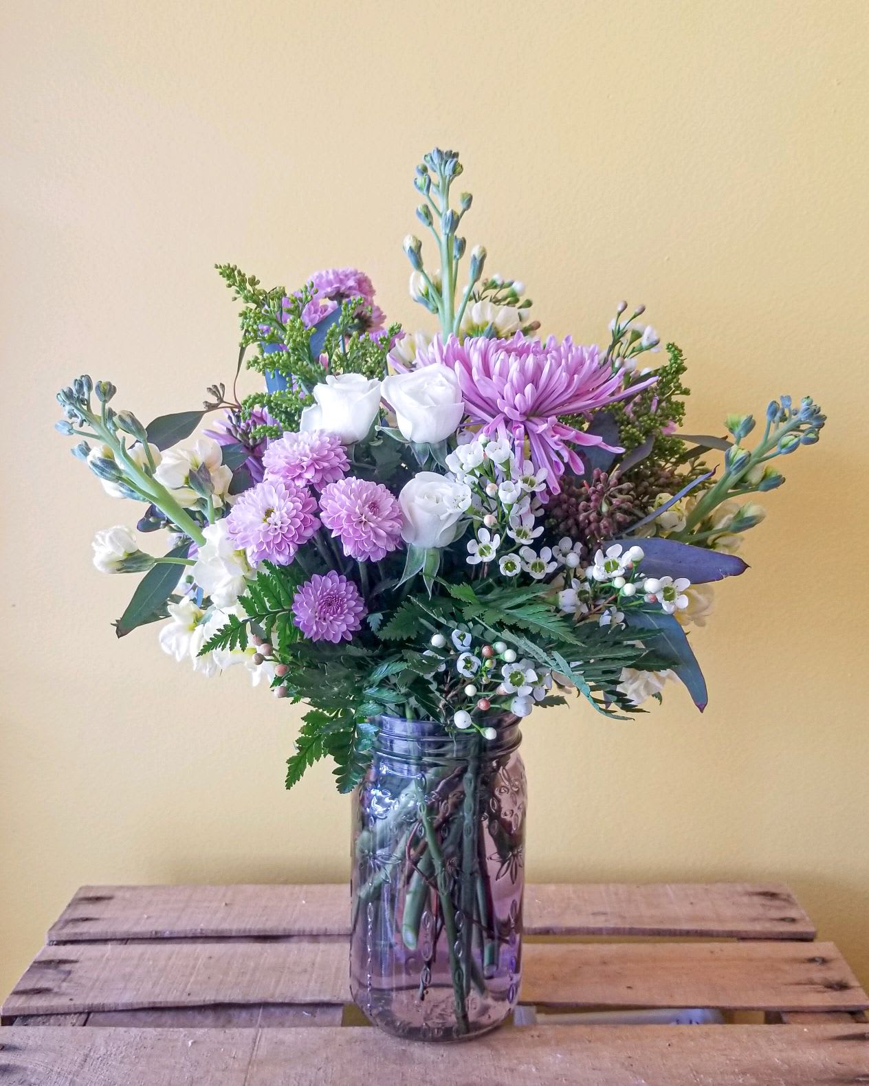Lavender Charm - A soothing sea of lavenders, purples and whites designed in a purple mason jar.  It's a charming, cheerful gift for any occasion! H-12.5in x W-10in