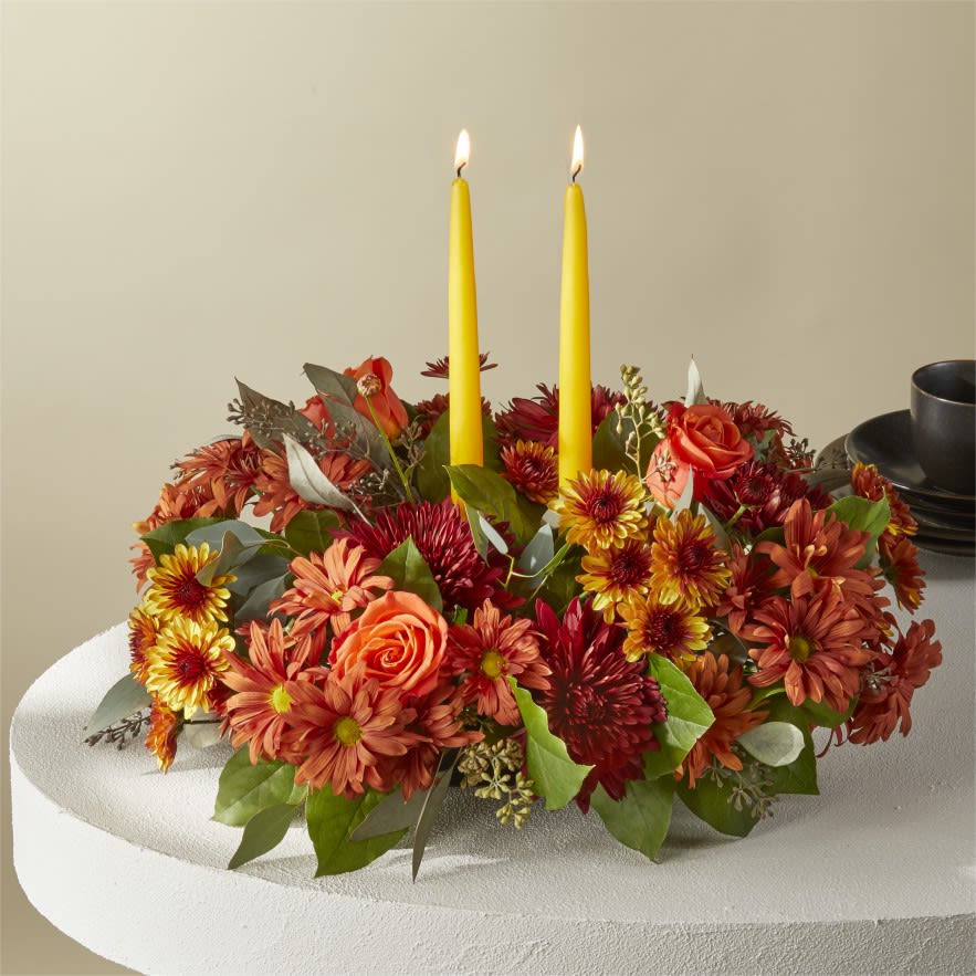 Ember Memories Centerpiece Ember Memories Centerpiece - Cast your holiday meals in a whole new light with this lovely centerpiece, which draws from the season's most stunning bronze, red and orange florals and foliage.   V5457d