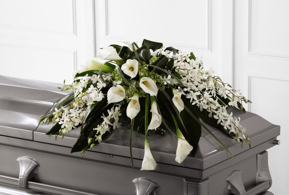 FTD Angel Wings Casket Spray - The FTD Angel Wings Casket Spray is an exceptionally gorgeous way   to bring peace and beauty to their final farewell service. White   Dendrobium orchids, white calla lilies, green hydrangea and a variety of   lush greens are artfully arranged to perfectly adorn the top of their   casket, offering the colors and ambience of grace and serenity.      0&quot;&quot;h x 36&quot;&quot;w  &quot;