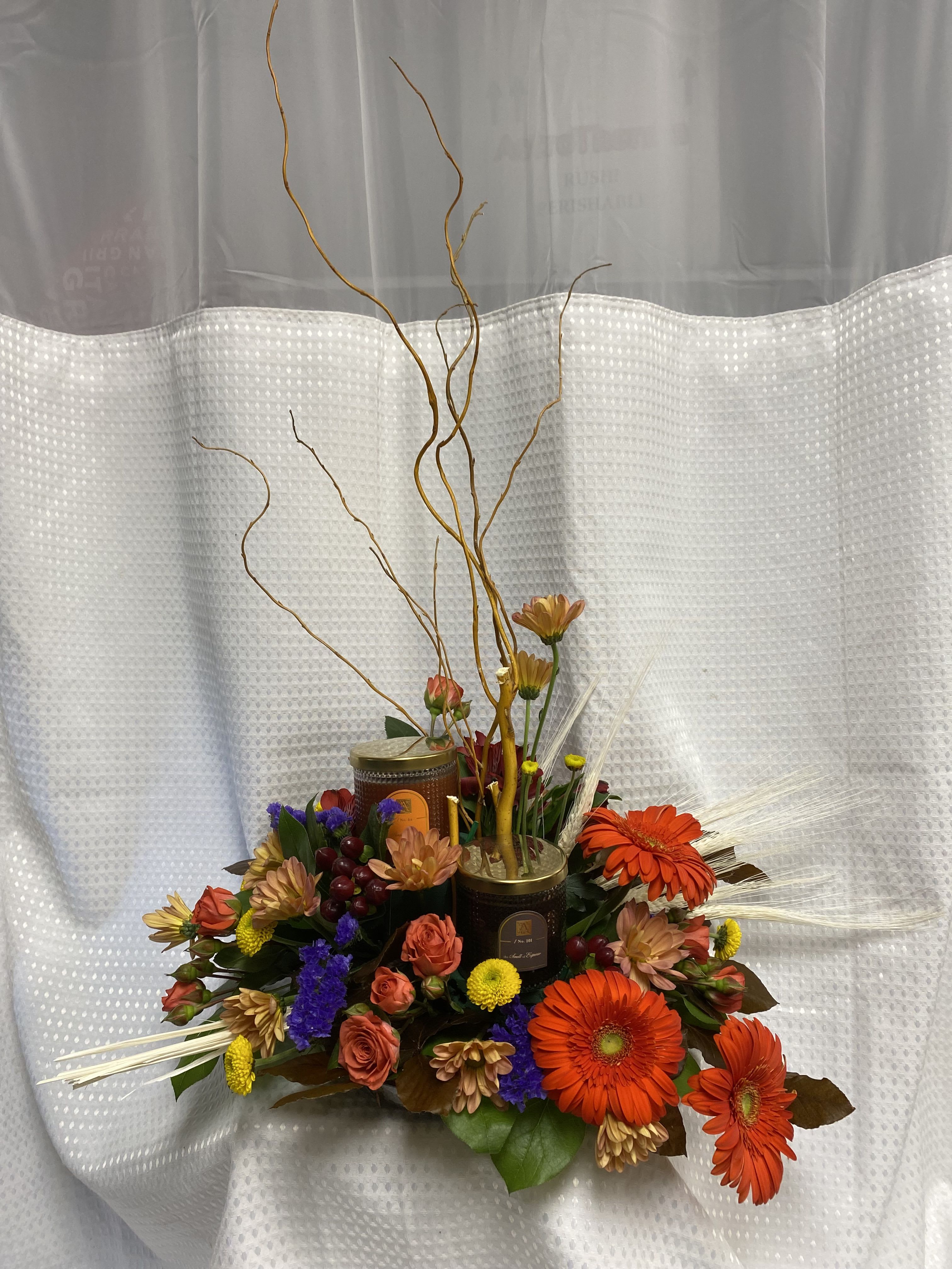 Pumpkin Spice Latte Floral and Candle Set Pumpkin Spice Latte Floral and Candle Set - This beautiful floral design is full of spectacular fall flowers and at the center is two candles! One candle is Pumpkin Spice and the other is Smell of Espresso! Burn them together for the perfect Pumpkin Spice Latte scent or separately to get each candles distinctive scent.