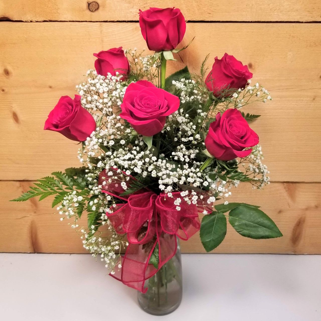 Love's Embrace Red Love's Embrace Red - Embrace your feelings with a classic gift of six red roses. Displayed elegantly in a glass vase and artistically designed by our select florists, these stunning roses send a memorable message to your special someone that help you express yourself perfectly, no matter what the occasion.