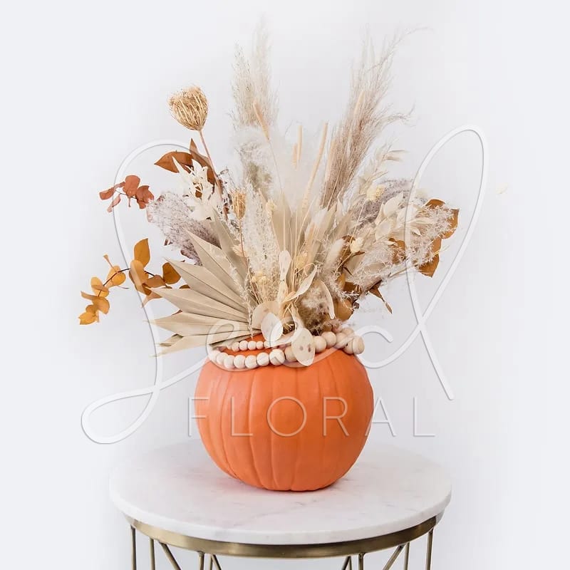 Pampas Pumpkin Pampas Pumpkin - The perfect boho fall decor for your porch or inside your home! Featuring a mix of neutral toned dried flowers in Faux Pumpkin, finished off wood mala beads! Snag one while you can!   Approx 18" tall