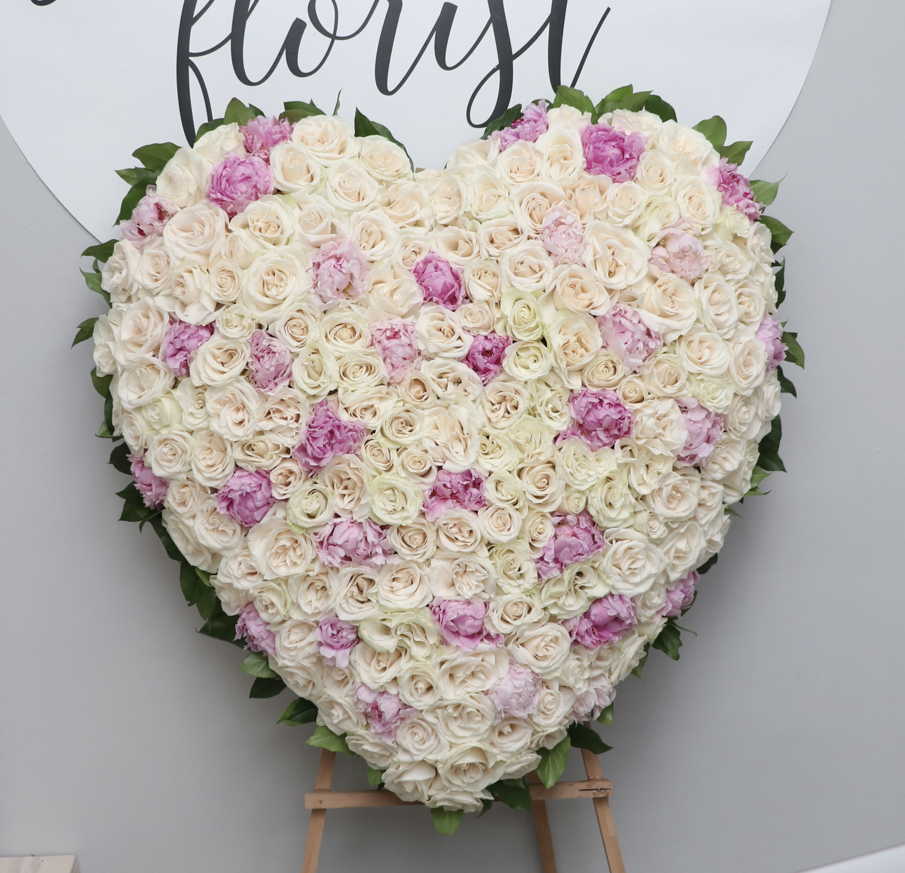 Snowfall &amp; Spring Full Heart  - This full heart comes covered in all white and pink roses. Each upgrade will include more premium flowers.   We include easel, printed banner and delivery (some fees may apply). An additional banner can be added for $15  Standard size is 30'', deluxe is 36'', and premium is 42''.